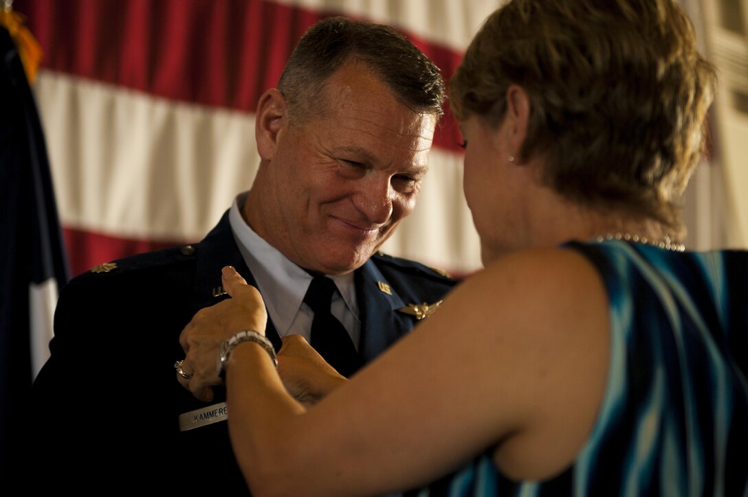 U.S. Air Force Lt. Col. Robert Kammerer, 316th Training Squadron Commander, receives his command pin from his wife Deborah Kammerer during the 316th TRS Change of Command at the Fire Academy high bay on Goodfellow Air Force Base, Texas, June 30, 2017. The command pin signifies a commander of a squadron, group, wing, or major command. (U.S. Air Force photo by Senior Airman Scott Jackson/Released)