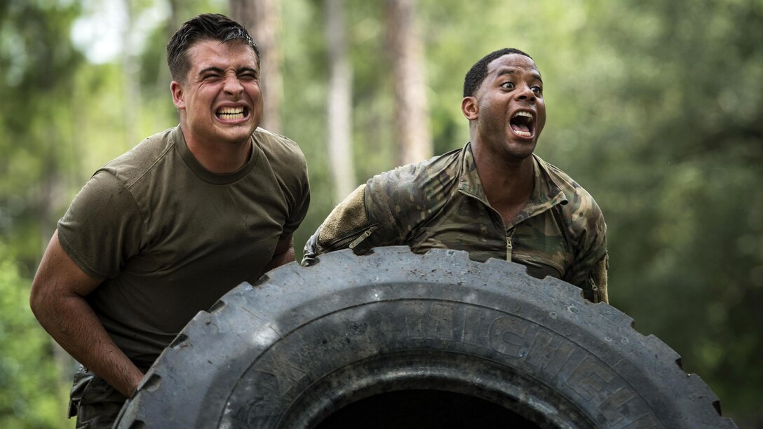 Airmen flip a tire during the Scorpion Fire Team Challenge at Moody Air Force Base, Ga., June 29, 2017. The airmen are assigned to the 822nd Base Defense Squadron. The challenge includes written tests and physical and skills competitions. Air Force photo by Senior Airman Janiqua P. Robinson