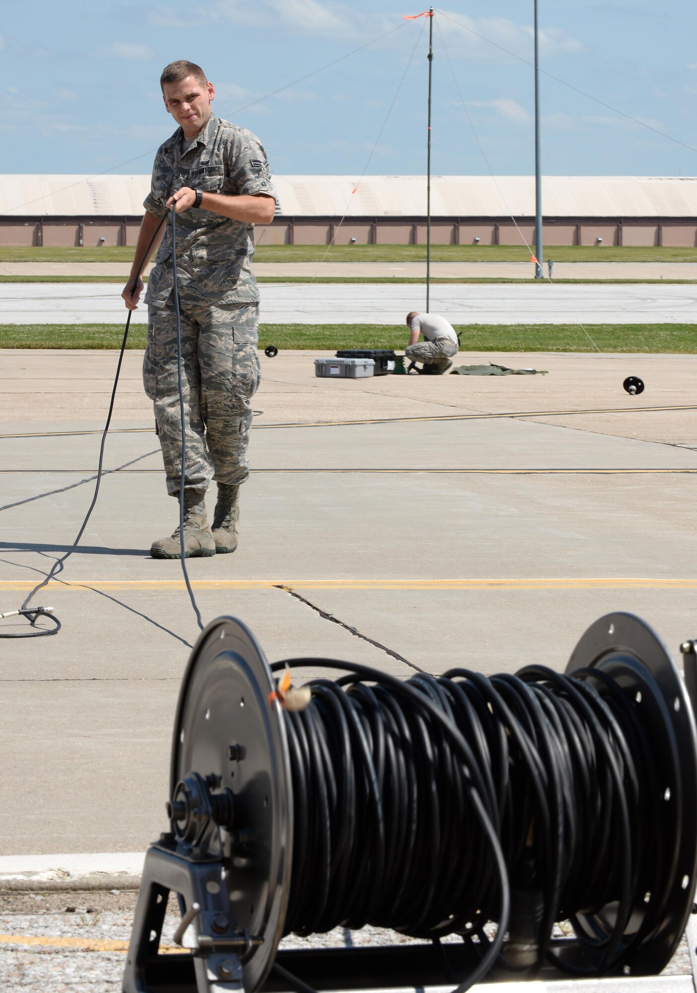 Airman 1st Class Killian Mantyh, 55th Strategic Communications Squadron tactical radio technician, sets up a satellite communications terminal while testing communications required for mobile nuclear command and control capabilities with command post personnel at Offutt Air Force Base, Neb. June 27. (U.S. Air Force photo by Delanie Stafford)