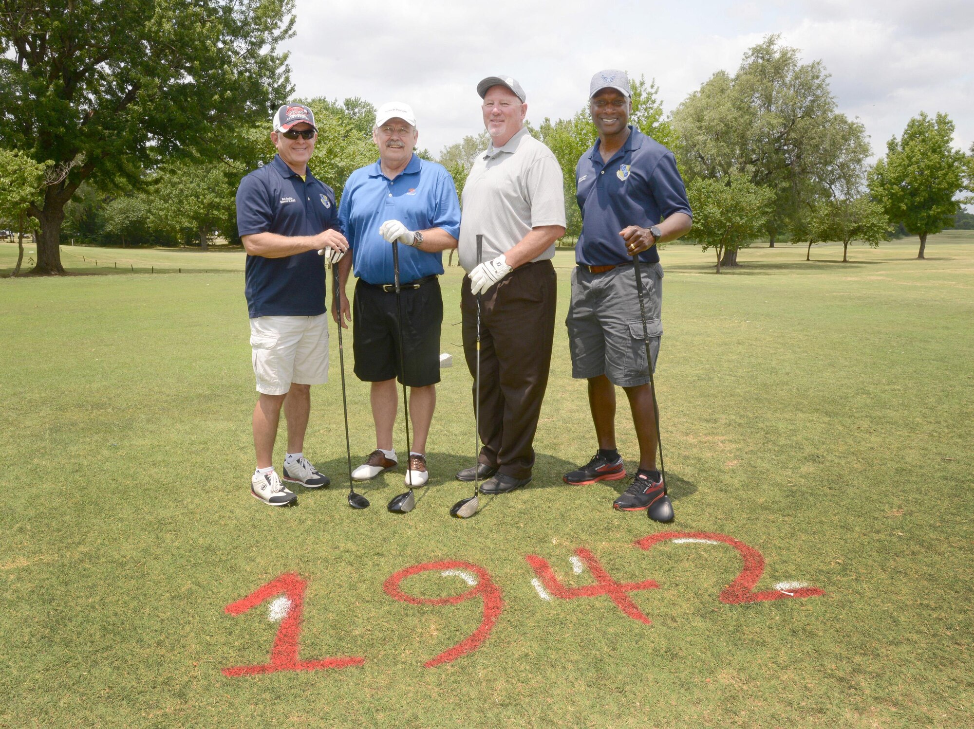 Before they teed off, 72nd Air Base WingDirector of Staff Bob Sandlin, Oklahoma District 42 Senator Jack Fry, Oklahoma State Representative for District 95 Roger Ford and 72nd Air Base Wing Commander Col. Kenyon Bell posed for a quick photo at Tinker's 75th Anniversary Golf Tournament. All holes at the Tinker Golf Course were renamed for the event according to a significant year in Tinker's history. Hole #1 was renamed Hole 1942, signifying the year of the activation of Midwest Air Depot.