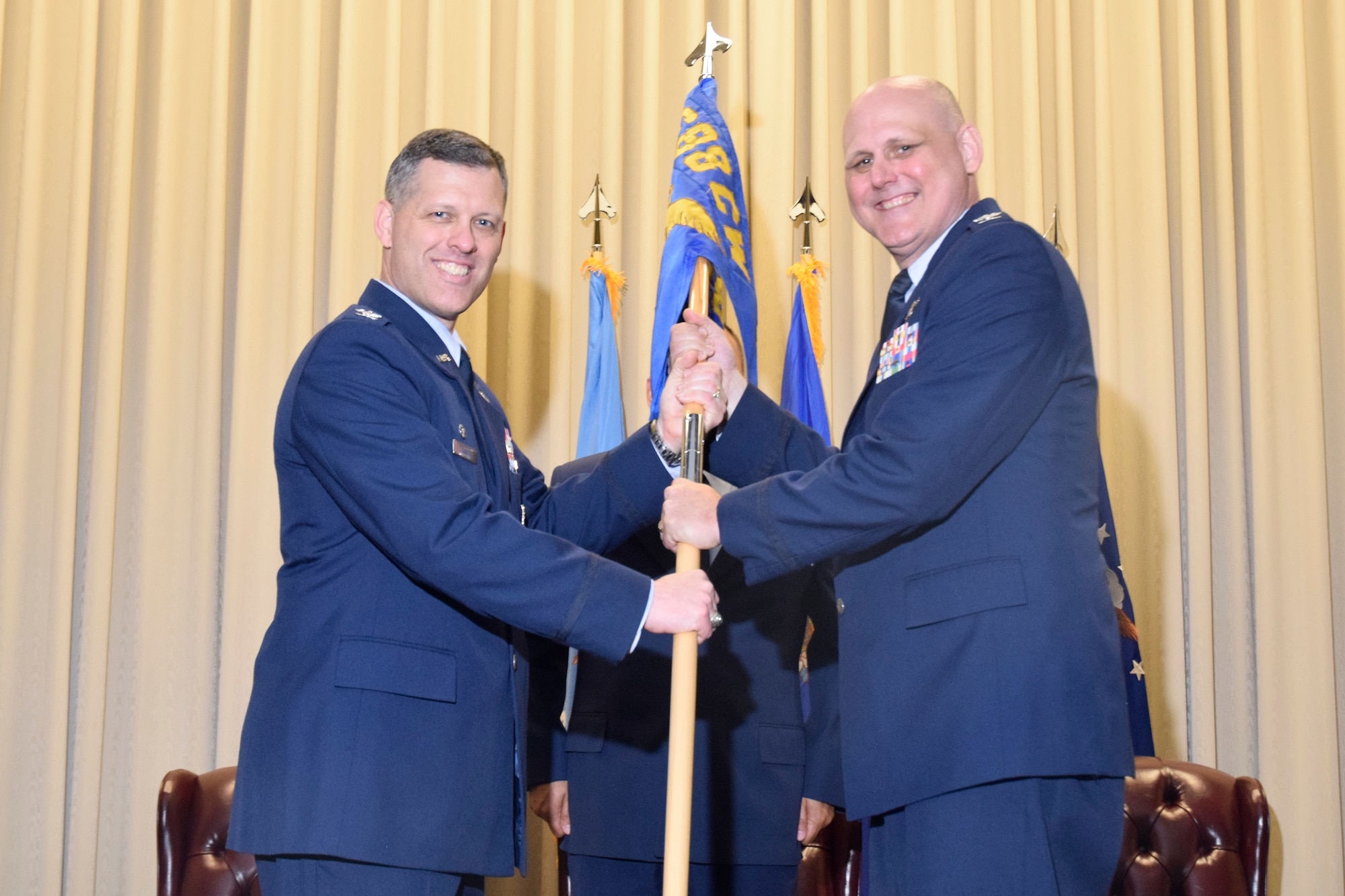 Col. Eric P. DeLange, 688th Cyberspace Wing commander, Joint Base San Antonio-Lackland, Texas, passes the unit guidon to Col. Todd S. Schug, as he assumes command of the 38th Cyber Engineering Installation Group, June 23, 2017, Tinker Air Force Base, Oklahoma. Schug replaces Col. Stan Diamanti who has been reassigned to Colorado. (U.S. Air Force photo/Greg L. Davis)