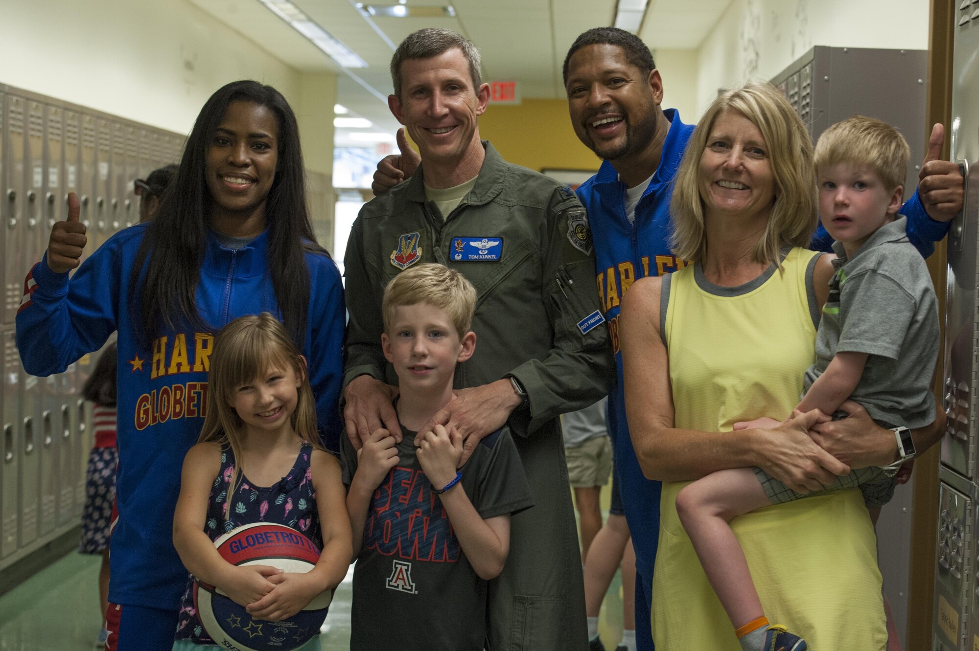 Col. Thomas Kunkel, 23d Wing Commander, and family pose for a photo with Harlem Globetrotters “Handles” and “TNT” after a show, June 30, 2017, at Moody Air Force Base, Ga. During their visit, the globetrotters performed tricks, interacted with children, and instilled life lessons such as anti-bullying and the importance of school. (U.S. Air Force photo by Airman 1st Class Lauren M. Sprunk)
