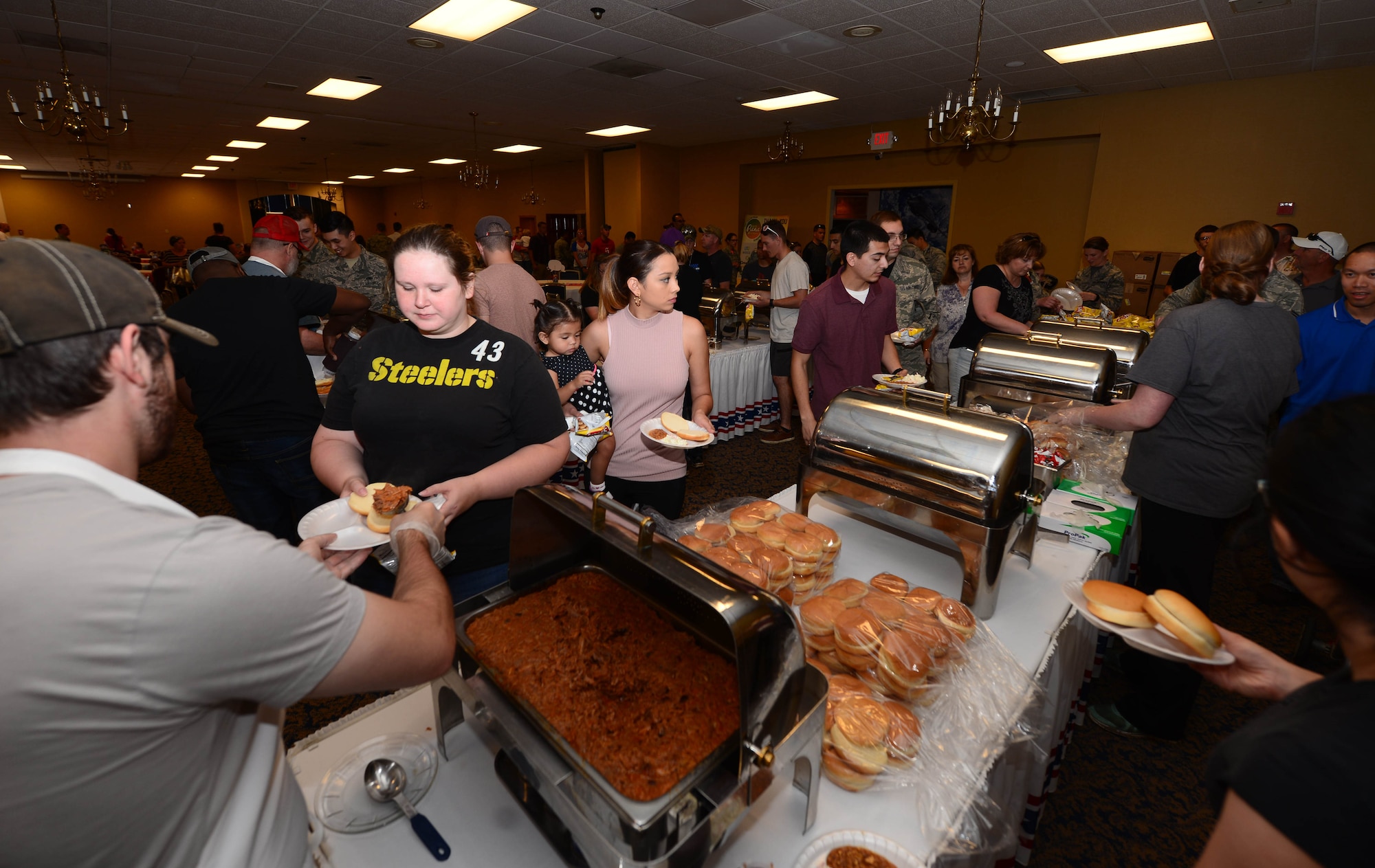 Airmen and families line up for food during the annual base picnic in the Dakota’s Club at Ellsworth Air Force Base, S.D., June 30, 2017. The picnic was held to thank Ellsworth Airmen and their families for the hard work and the dedication they invest into keeping the mission going. (U.S. Air Force photo by Airman 1st Class Donald C. Knechtel)