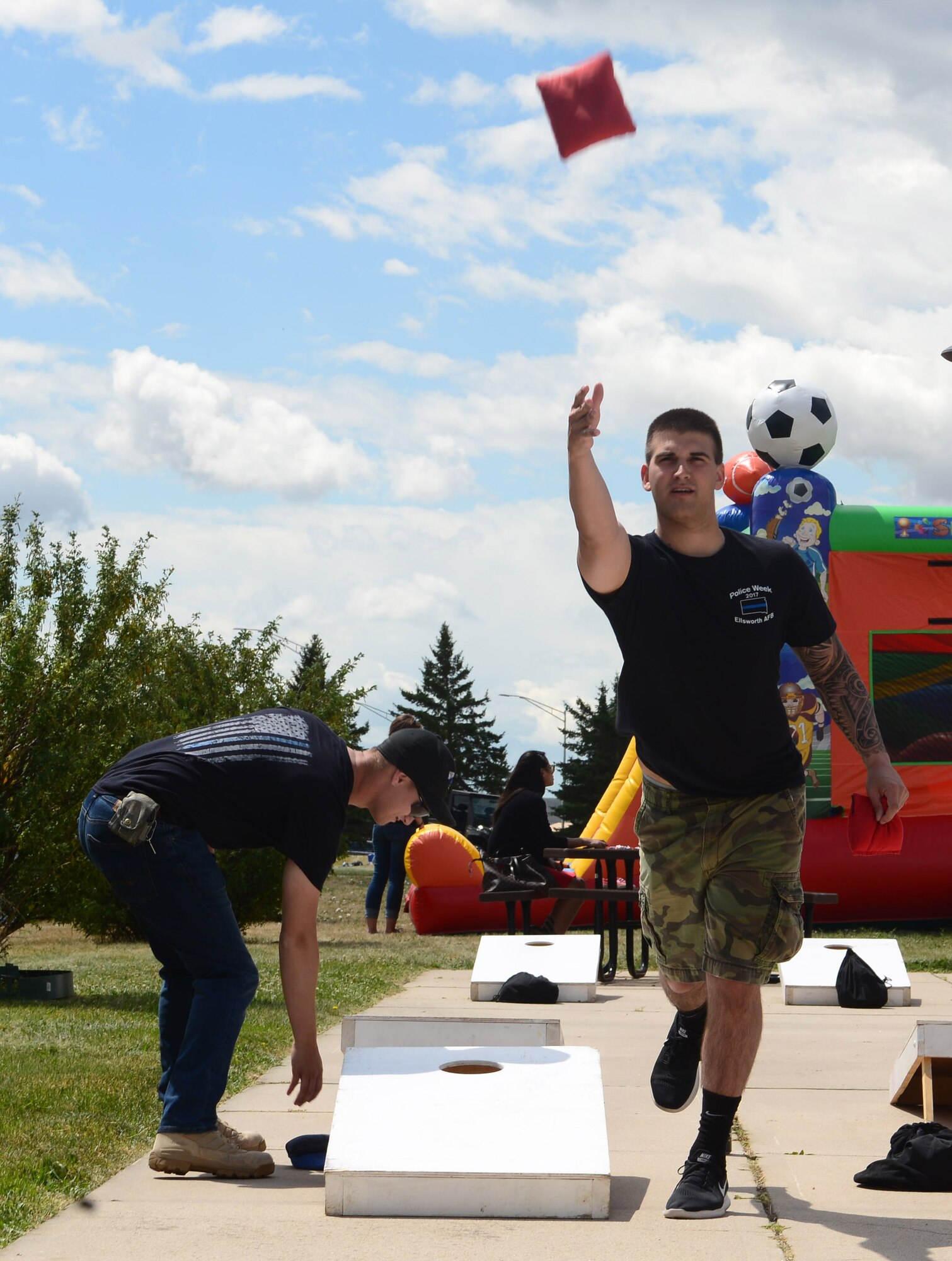 Airmen play a game of bean bag toss during the annual base picnic at Ellsworth Air Force Base, S.D., June 30, 2017. The event included a variety of activities for Airmen and their families to participate in including paintball, bubble soccer and bounce houses for children. (U.S. Air Force photo by Airman 1st Class Donald C. Knechtel)