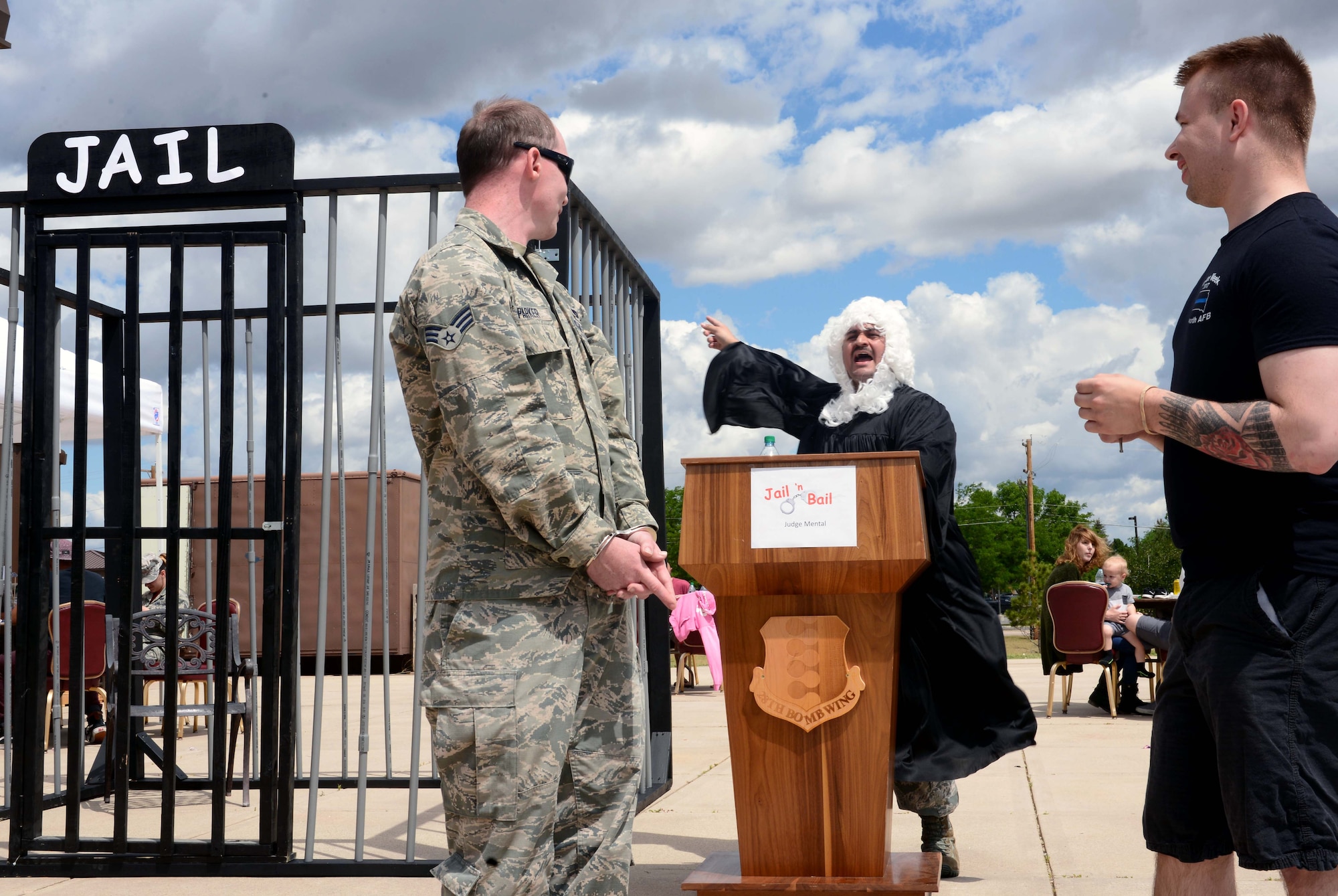 Senior Airman Cameron Parker, a response force leader assigned to the 28th Security Forces Squadron, is sentenced to jail by “Judge Mental” during the annual base picnic at Ellsworth Air Force Base, S.D., June 30, 2017. During the picnic, attendees were given an opportunity to pay for a warrant for the arrest of an Airman of their choosing. (U.S. Air Force photo by Airman 1st Class Donald C. Knechtel)