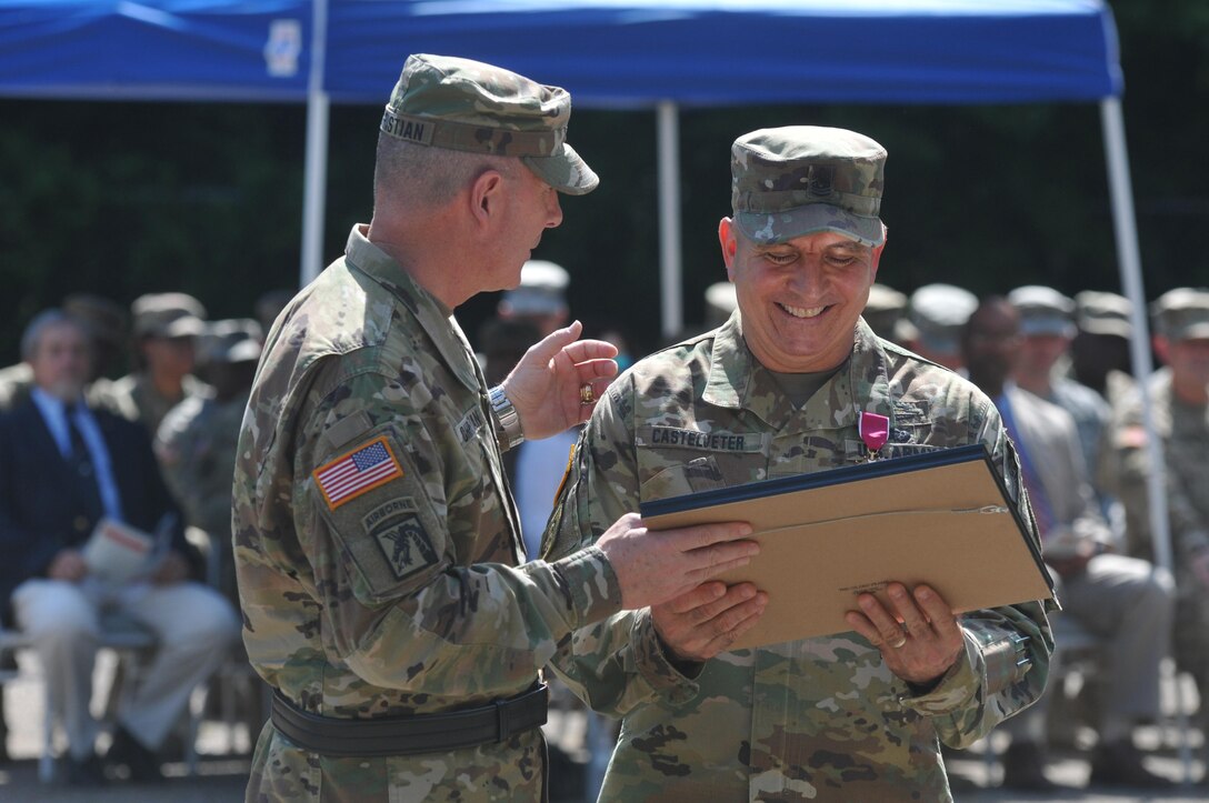 U.S. Army Reserve Command Sgt. Maj. Richard E. Castelveter, senior enlisted adviser of the 412th Theater Engineer Command, right, smiles as he and Brig. Gen. Daniel Christian, acting commander of the Command, share a moment about one of his many retirement awards during a change of responsibility and retirement ceremony at the George A. Morris Army Reserve Center in Vicksburg, Miss., June 10, 2017. Castelveter handed over his duties to Command Sgt. Maj. Dennis E. Law and retires after more than 35 years of honorable service. (U.S. Army Reserve Photo by Sgt. 1st Class Clinton Wood)