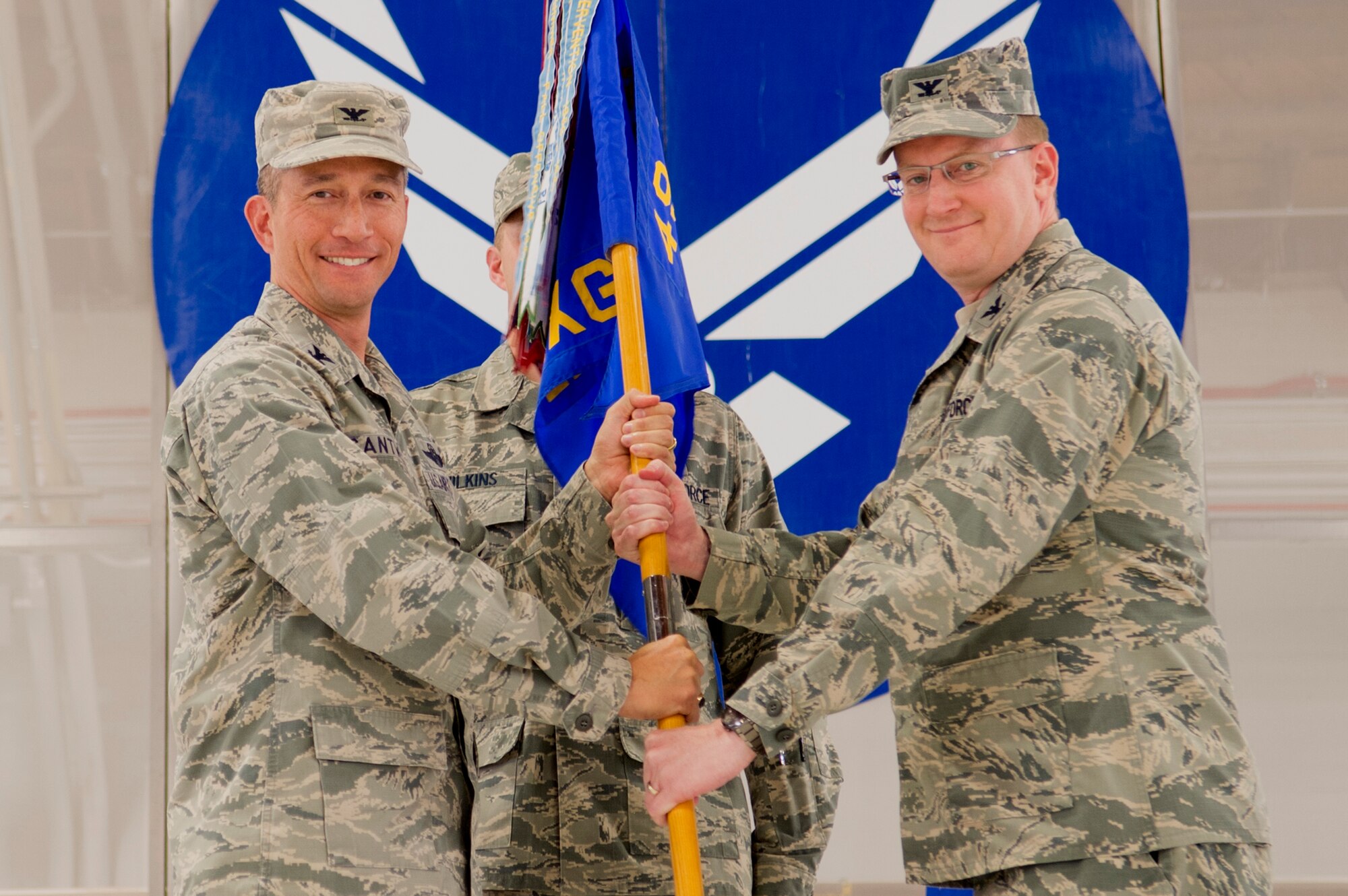 Col. Houston Cantwell, 49th Wing commander, gives the 49th Maintenance Group guidon to Col. Tim Harbor during a change of command ceremony at Holloman Air Force Base, N.M., June 30, 2017. During the ceremony, Col. Harbor took command of the 49th MXG from Col. Lyle Drew, 49th MXG outgoing commander. (U.S. Air Force photo by Tech. Sgt. Amanda Junk)