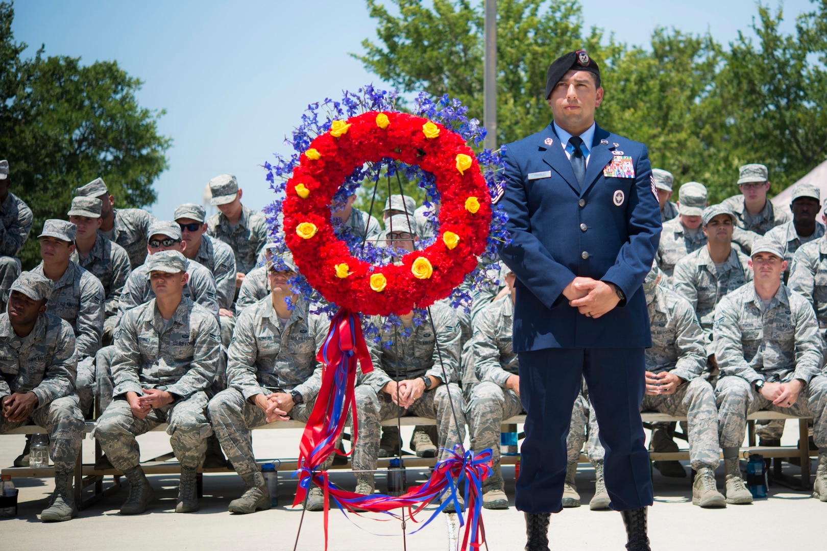 Master Sgt. Jeffery Mader stands next to the wreath during the Tactical Air Control Party Memorial Rededication Ceremony outside the 353rd Battlefield Airmen Training Squadron at the Joint Base San Antonio-Lackland Medina Annex June 23, 2017. Each of the gold roses placed on the wreath represent one of the fallen on the memorial. 