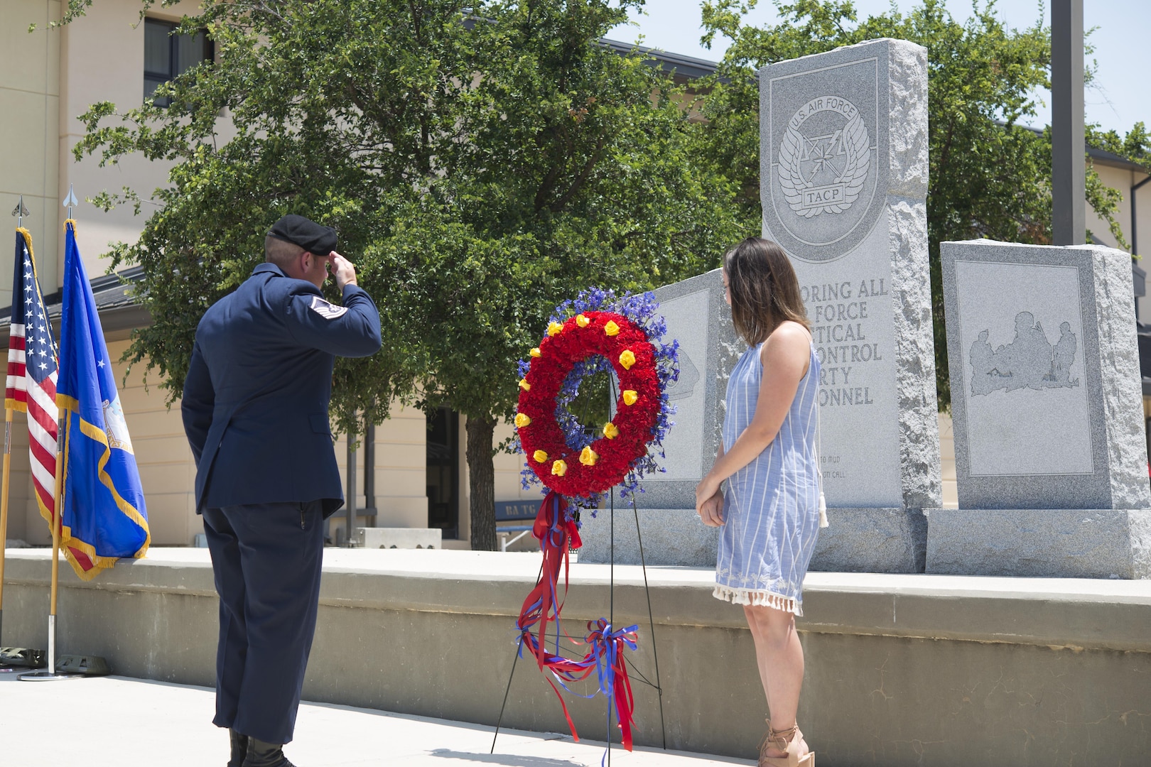 Master Sgt. Jeffery Mader places and salutes the wreath in front of the Tactical Air Control Party Memorial Rededication Ceremony outside the 353rd Battlefield Airmen Training Squadron at the Joint Base San Antonio-Lackland Medina Annex during a rededication ceremony June 23, 2017. Each one of the gold roses placed on the wreath represent one of the fallen TACP Airmen. 