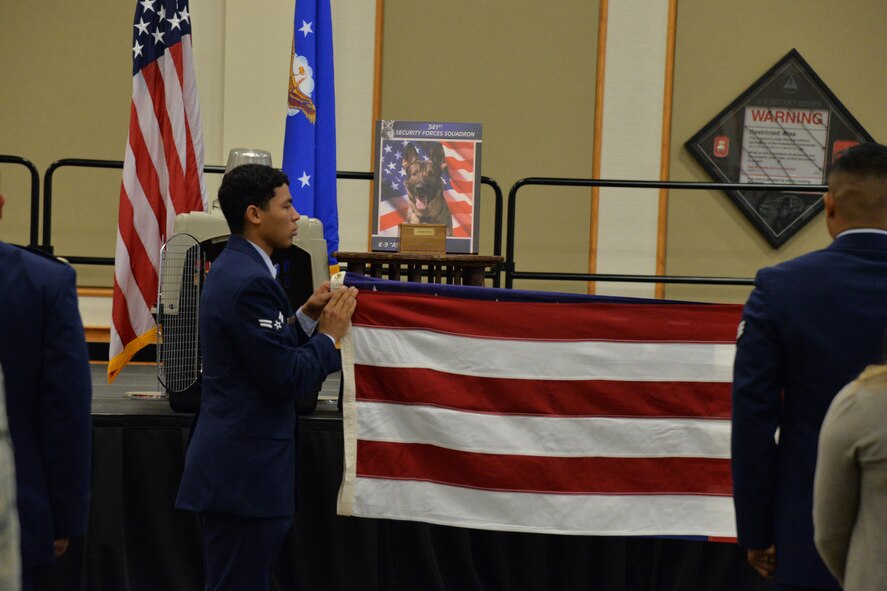 A flag is folded during a remembrance ceremony at the Grizzly Bend June 30, 2017, for MWD Aslan who passed away in early June. Taps was played during the folding of the flag as guests were able to pay their last respects. (U.S. Air Force photo/Airman 1st Class Daniel Brosam)