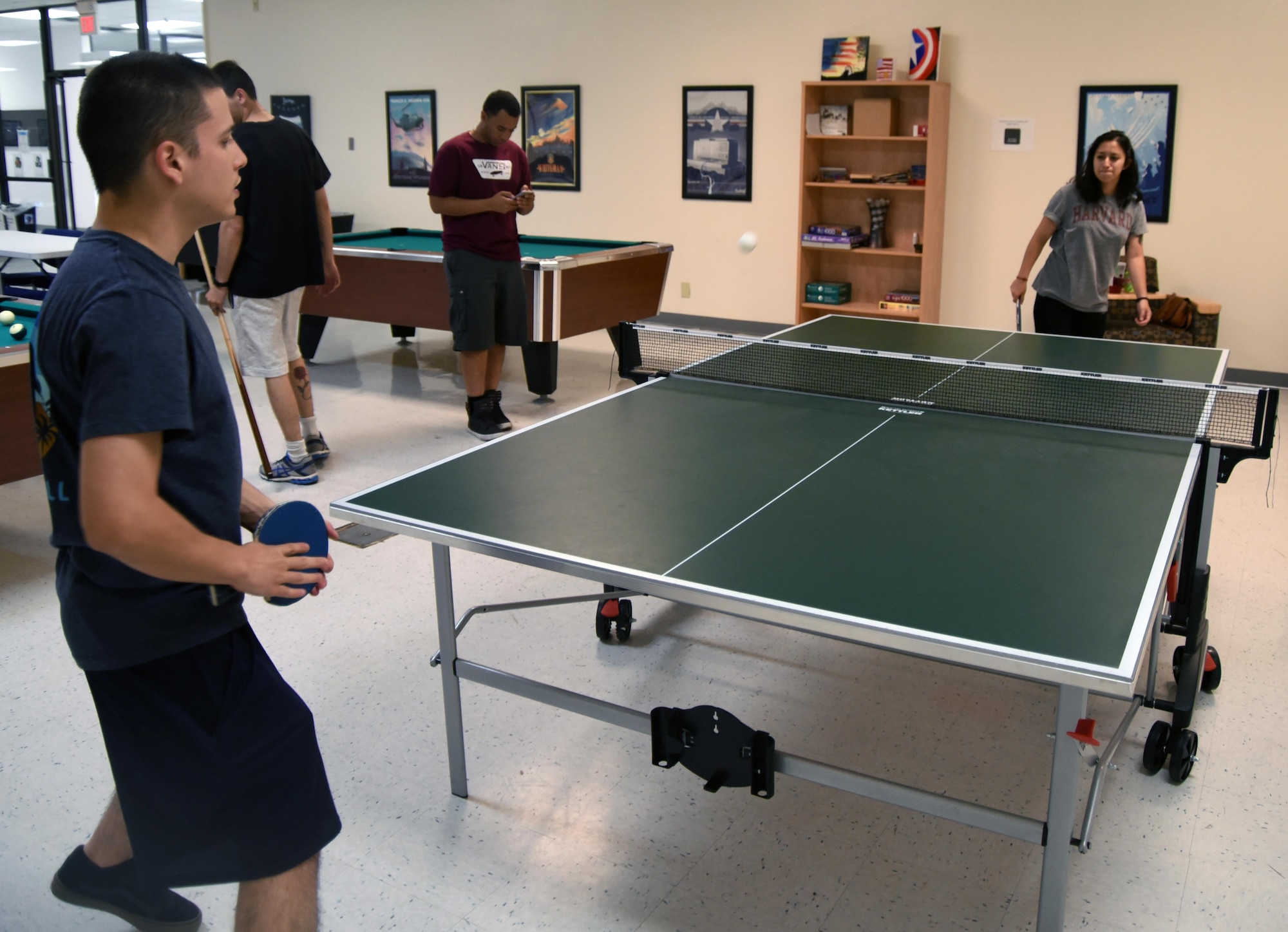 Two airmen play table tennis with each other at the Gravity Airman Ministry Center at Kirtland Air Force Base, New Mexico. Gravity hosts events every Thursday, Friday, and Saturday nights, and most holidays. (U.S. Air Force Photo by Senior Airman Chandler Baker)