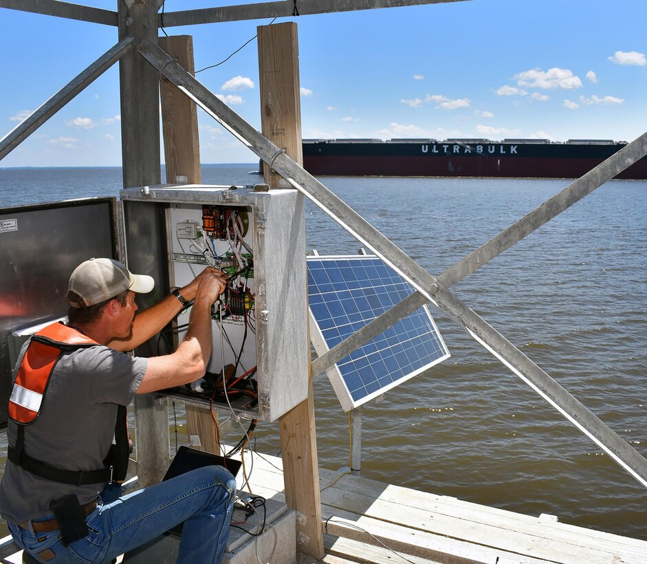 Sitting atop the U.S. Coast Guard navigation range in Mobile Bay, Coastal Engineer Richard Allen connects newly-installed gauges to the broadcast system which provides data communication to the Corps of Engineers. The gauges measure water level, wave height, turbidity, salinity and suspended sediment concentration.