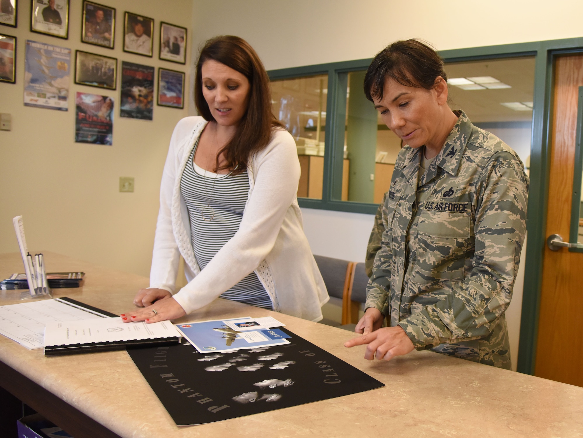Diana White, 81st Force Support Squadron marketing and commercial sponsorship/advertising director, shows printing samples to Col. Debra Lovette, 81st Training Wing commander, during a 81st Mission Support Group orientation tour at the McBride Commons June 29, 2017, on Keesler Air Force Base, Miss. The tour familiarized Lovette with the group’s mission, operations and personnel. (U.S. Air Force photo by Kemberly Groue)
