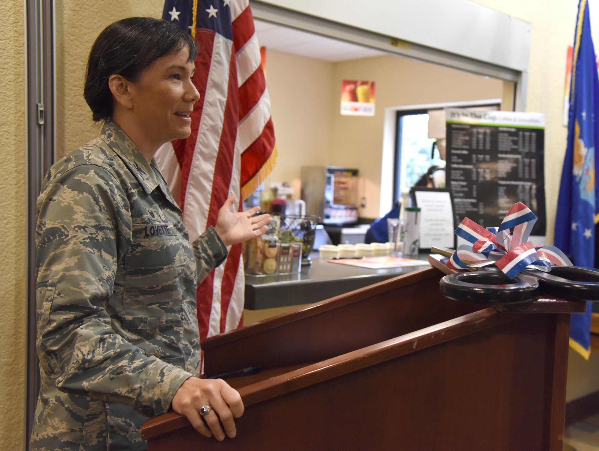 Col. Debra Lovette, 81st Training Wing commander, delivers remarks during the “It Is In The Cup” ribbon cutting ceremony in the Bay Breeze Event Center June 29, 2017, on Keesler Air Force Base, Miss. Keesler's new coffee & smoothie bar serves Starbucks coffee, Frappuccino’s, iced beverages and espresso as well as Island Oasis smoothies in a variety of flavors. A full menu of items can be found at www.keesler81fss.us. (U.S. Air Force photo by Kemberly Groue)


