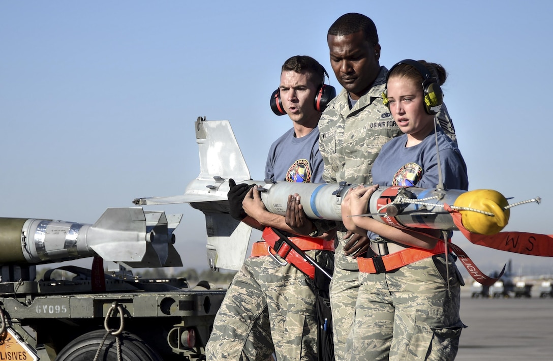 Airmen from the 57th Maintenance Group transport a missile during a load crew competition at Nellis Air Force Base, Nev., June 30, 2017. Squadrons from around the 57th Wing compete against each other to see who can most accurately and quickly arm an aircraft. (U.S. Air Force photo by Airman 1st Class Andrew D. Sarver/Released)