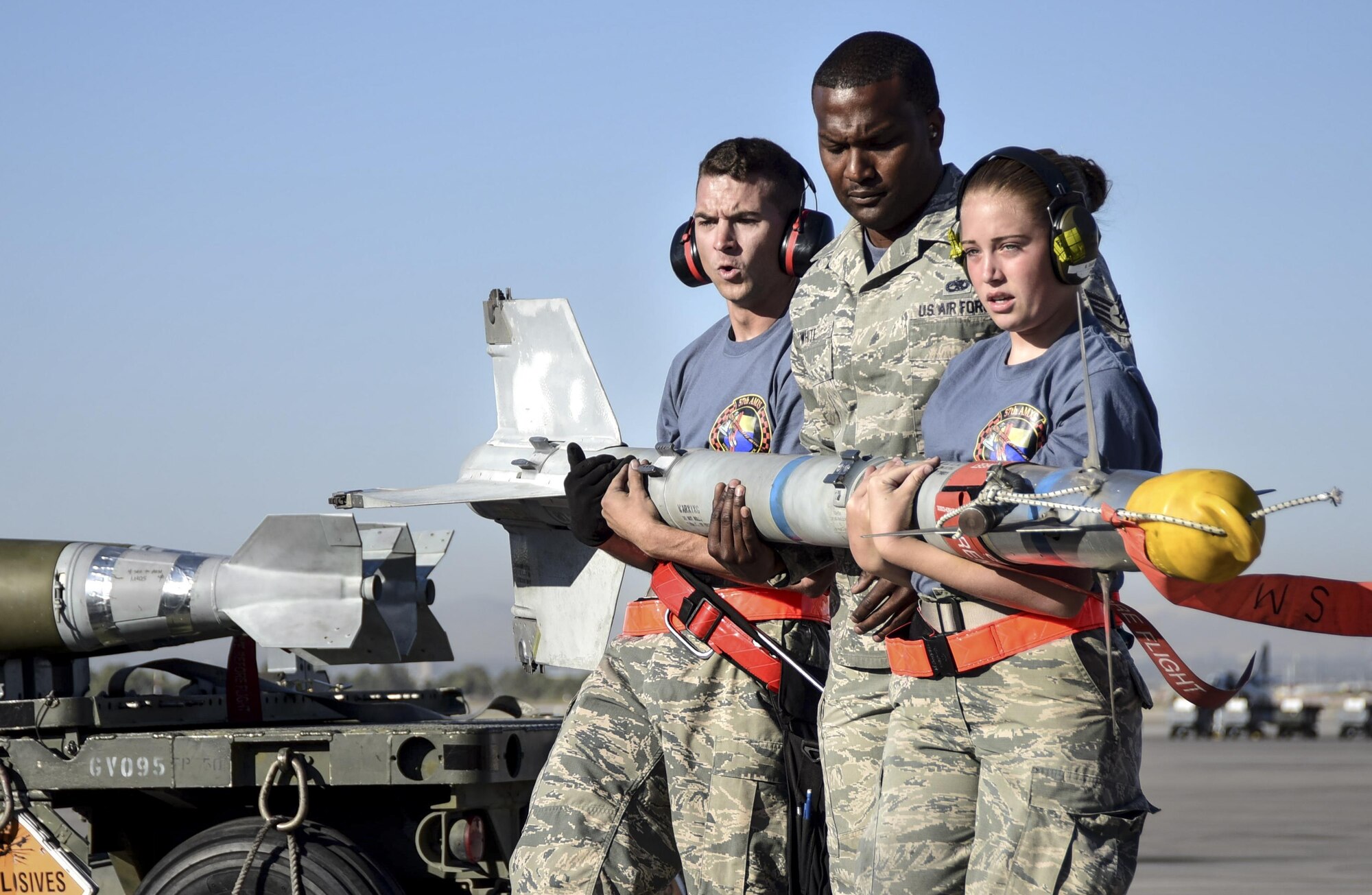 Airmen from the 57th Maintenance Group transport a missile during a load crew competition at Nellis Air Force Base, Nev., June 30, 2017. Squadrons from around the 57th Wing compete against each other to see who can most accurately and quickly arm an aircraft. (U.S. Air Force photo by Airman 1st Class Andrew D. Sarver/Released)