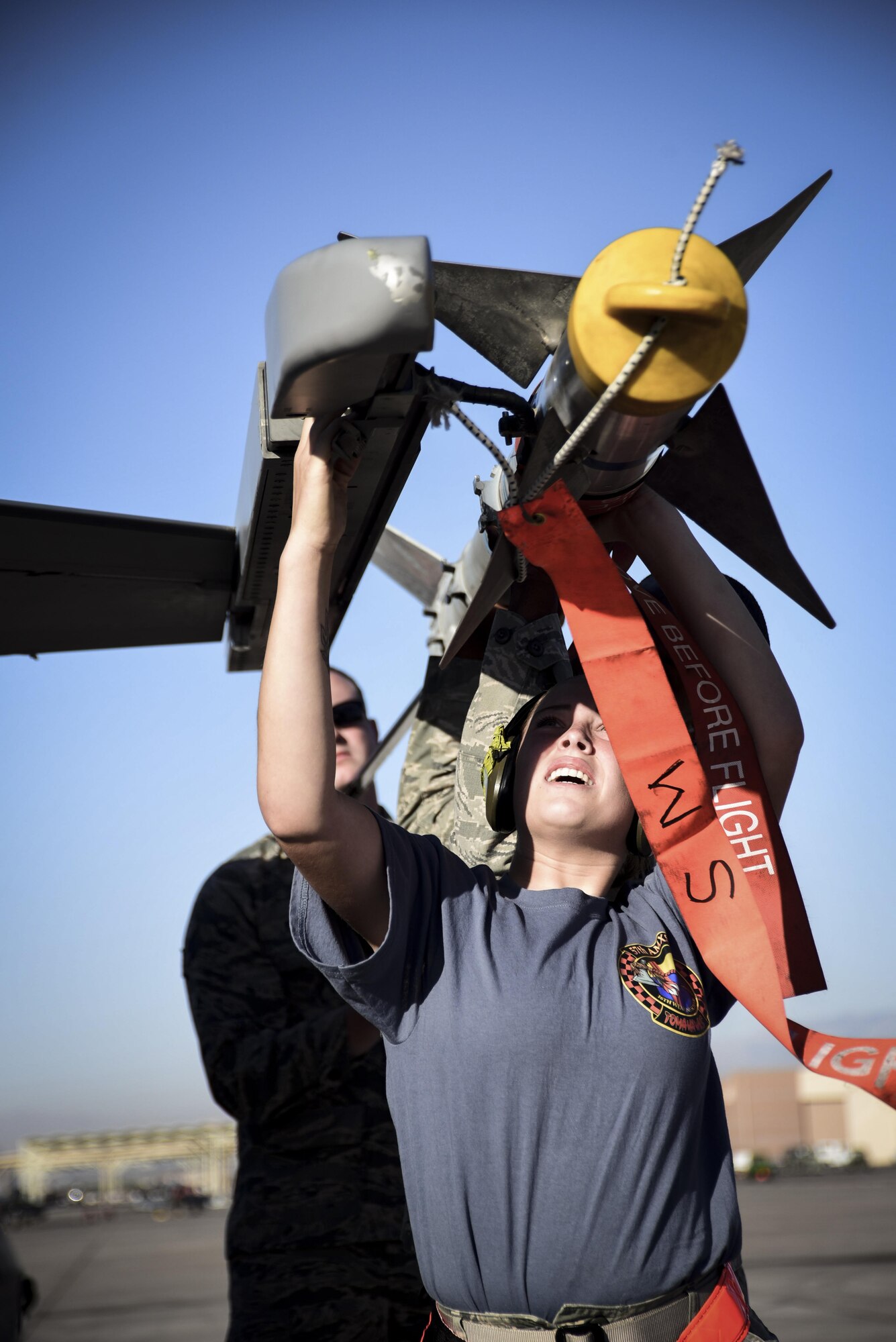 Airmen from the 57th Maintenance Group arm an F-16 Fighting Falcon, asigned to the 16th Weapons Squadron, during a load crew competition at Nellis Air Force Base, Nev., June 30, 2017. Small teams worked together to load multiple large munitions on the aircraft. (U.S. Air Force photo by Airman 1st Class Andrew D. Sarver/Released)