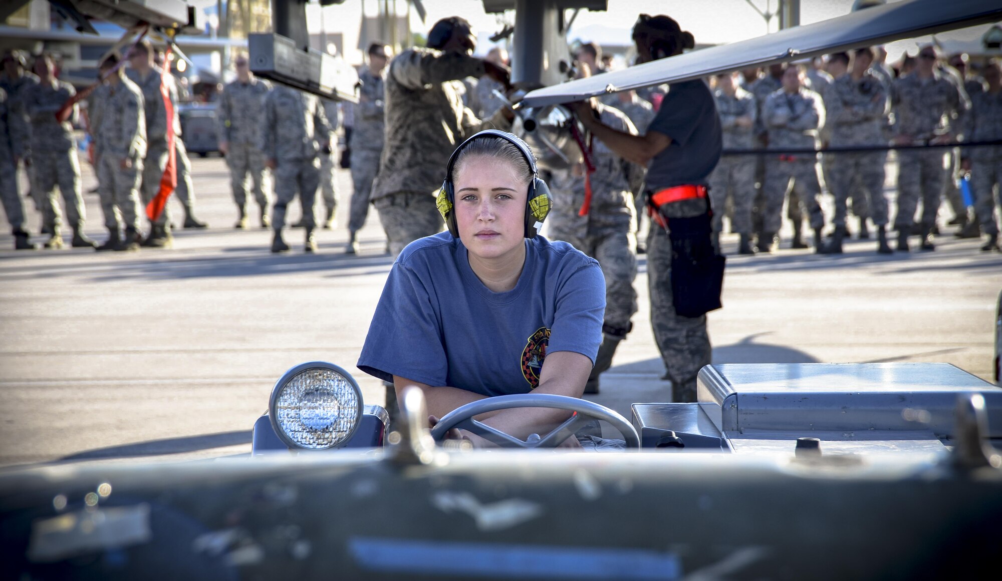 An Airman from the 57th Maintenance Group prepares to load a bomb on an F-16 Fighting Falcon, assigned to the 16th Weapons Squadron, during a load crew competition June 30, 2017, at Nellis Air Force Base, Nev. Each team member played a specific role during the competition. (U.S. Air Force photo by Airman 1st Class Andrew D. Sarver/Released)