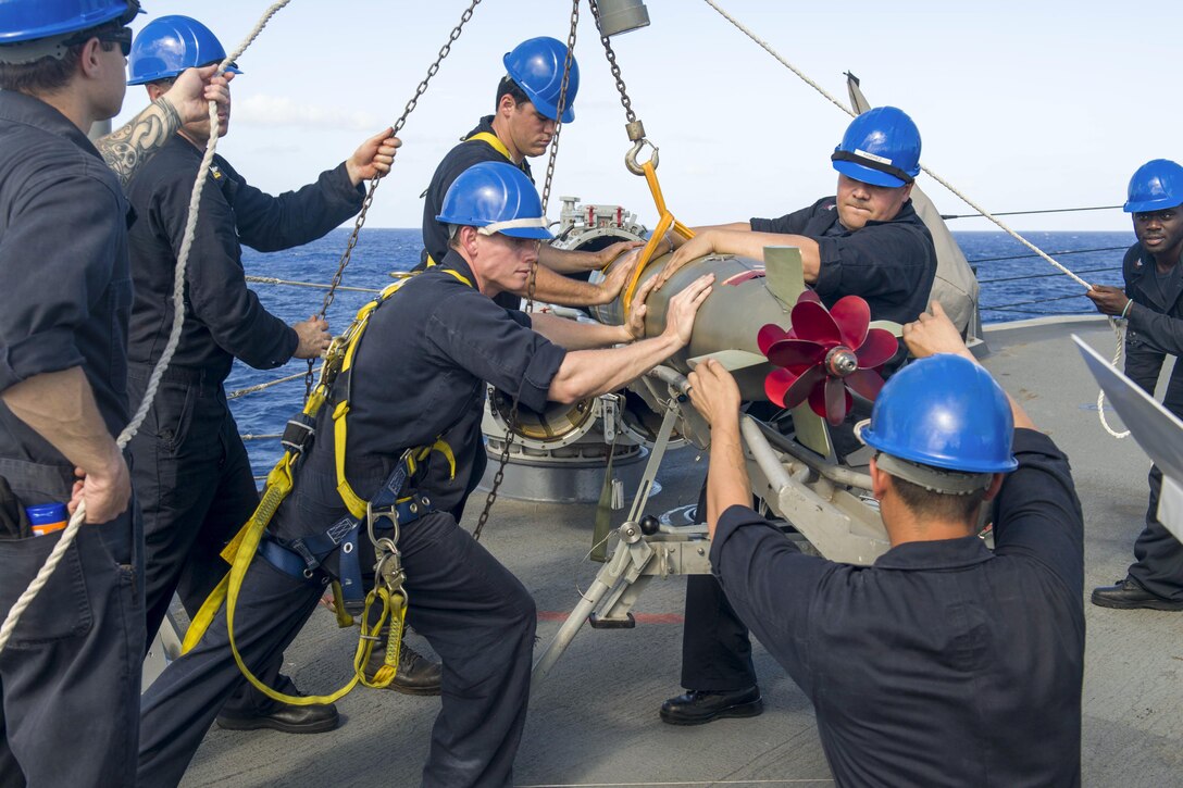 Sailors load an MK 46 torpedo into a surface vessel torpedo tube aboard the guided-missile destroyer USS Pinckney in waters off Guam, June 28, 2017. The Pinckney is operating in the U.S. 7th Fleet area of responsibility. Navy photo by Petty Officer 2nd Class Craig Z. Rodarte