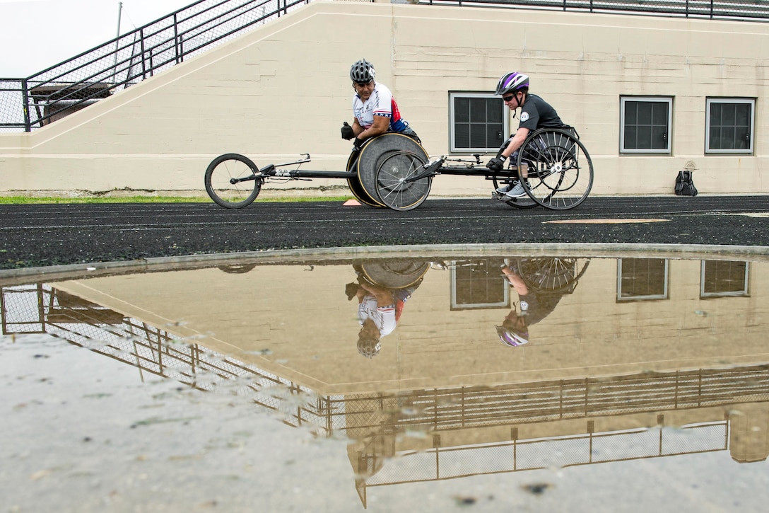 Team Army Coach Saul Mendoza, left, instructs Army Staff Sgt. Rachel Salemink in wheelchair race practice for the 2017 Department of Defense Warrior Games in Chicago, June 30, 2017. DoD photo by EJ Hersom