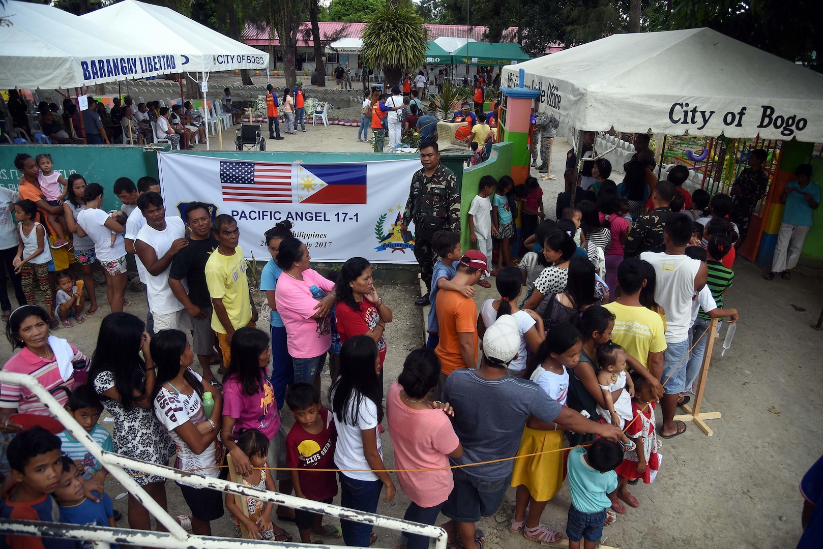 Local community member’s form a line outside of a Pacific Angel 2017 health services site in Northern Cebu Province, Bogo City, Philippines, June 26, 2017. PACANGEL is a multilateral humanitarian assistance civil military engagement, which improves military-to-military partnerships in the Pacific while also providing medical health outreach, civic engineering projects and subject matter exchanges among partner forces. 