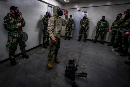 Pfc. Charles M. Burroughs, a La Plata, Maryland native and Chemical, Biological, Radiological, Nuclear specialist with 1st Battalion, 3rd Marine Regiment, instructs Marines during annual gas chamber qualification aboard Camp Hansen, Okinawa, Japan, June 26, 2017. The annual training familiarizes Marines with the use of their gas mask to prepare them for a biological or chemical attack. The Hawaii-based battalion is forward deployed to Okinawa, Japan as part of the Unit Deployment Program. (U.S. Marine Corps photo by Cpl. Aaron S. Patterson/Released)