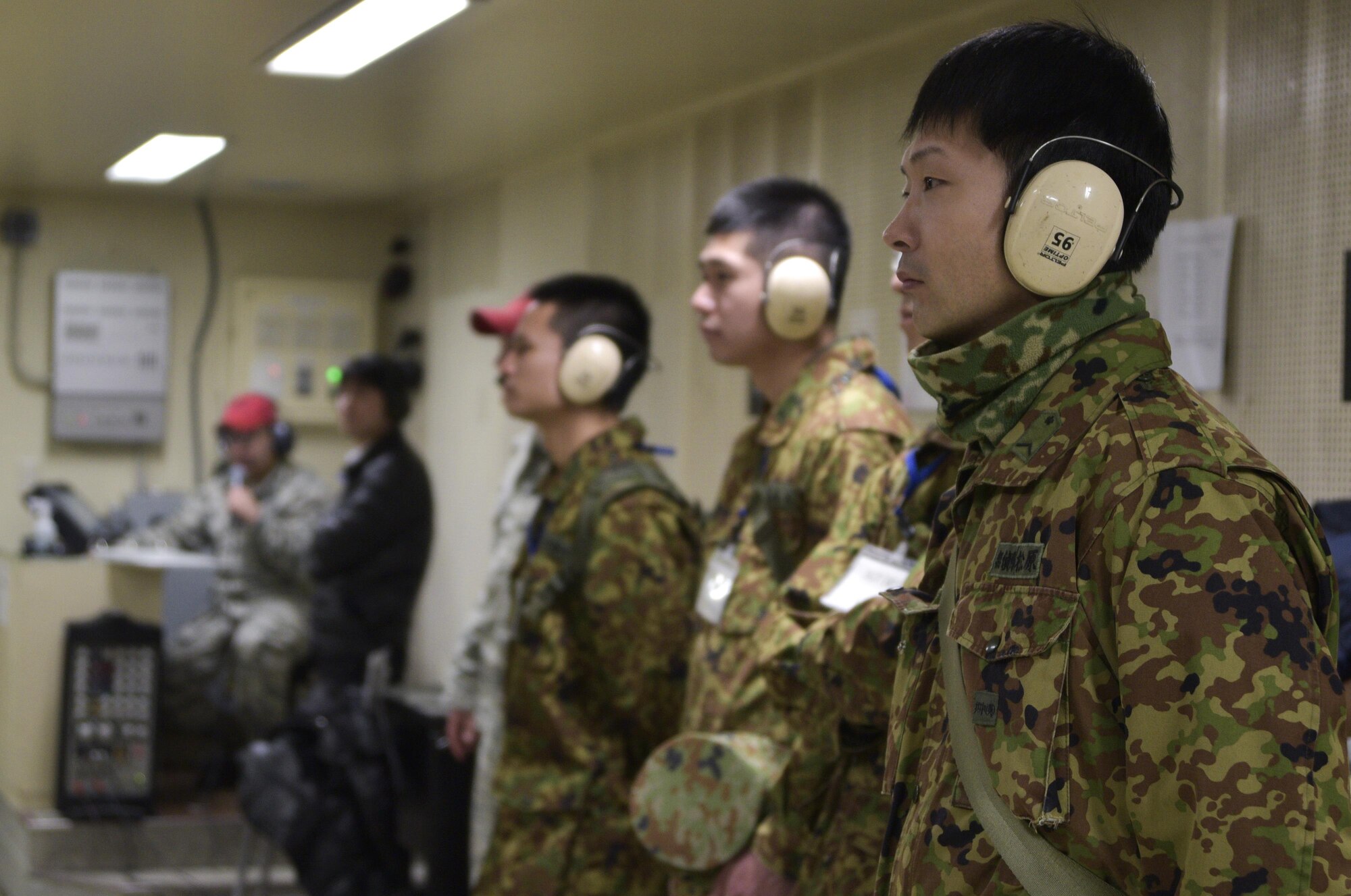 Japan Ground Self-Defense Force soldiers observe a weapons qualifying course in the Combat Arms Training and Maintenance range at Misawa Air Base, Japan, Feb. 22, 2017. JGSDF soldiers spent three days shadowing U.S. Airmen so they could apply the English they learned over the past three months. (U.S. Air Force photo by Staff Sgt. Melanie A. Hutto)