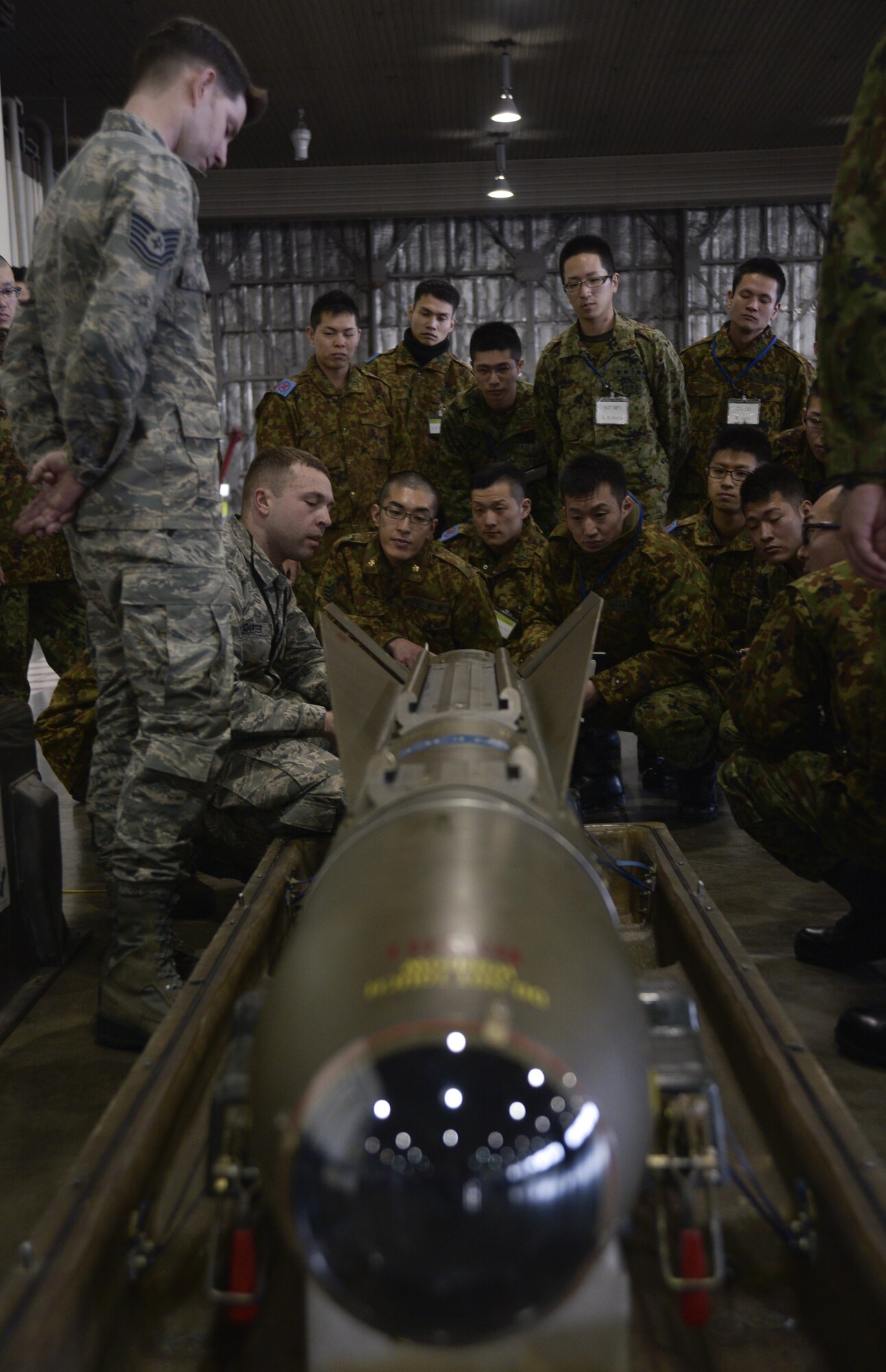 U.S. Air Force Tech. Sgt. Nathan Monica, left, a lead standardization crew member, and Senior Airman Robert Carter, right, a weapons load crew member, both with the 35th Maintenance Group, show the ignitor cable of an AGM-65 Maverick to Japan Ground Self-Defense Force soldiers at Misawa Air Base, Japan, Feb. 23, 2017. The AGM-65 Maverick is a tactical, air-to-surface guided missile designed for close air support and the defense suppression mission. (U.S. Air Force photo by Staff Sgt. Melanie A. Hutto)
