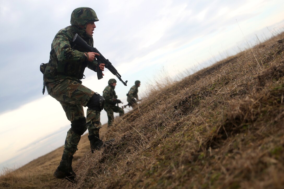 Serbian soldiers rush to an objective at Smardan Training Area, Romania, Feb. 23, 2017. The training was a part of Exercise Platinum Eagle, a multinational exercise with allies in the Black Sea region to increase interoperability through combined-arms training. Marine Corps photo by Cpl. Sean J. Berry