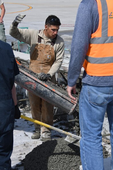 U.S. Air Force Staff Sgt. Zachary Costa, a heavy equipment and constructions journeyman with the 379th Expeditionary Civil Engineer Squadron Pavements and Equipment Flight, pours concrete at Al Udeid Air Base, Qatar, Feb. 21, 2017. The 379th ECES “Dirt Boyz” replaced several concrete pads on the flightline after they had become uneven, which resulted in breaking the record at Al Udeid for the largest single day concrete pouring. (U.S. Air Force photo by Senior Airman Miles Wilson)