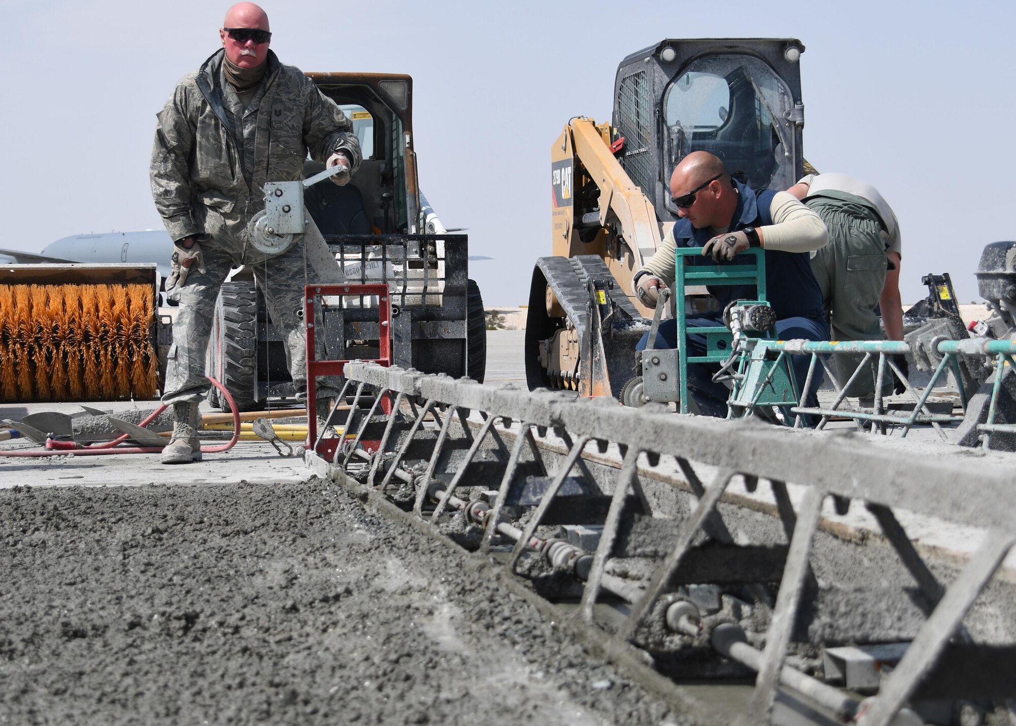 U.S. Air Force Tech. Sgt. Jonathan Bacon, a heavy equipment and constructions craftsman with the 379th Expeditionary Civil Engineer Squadron Pavements and Equipment Flight, cranks a lever on an A-frame screed at Al Udeid Air Base, Qatar, Feb. 21, 2017. The A-frame screed is a tool used for leveling concrete and settles the aggregate rock and gravel to the bottom of the mix while bringing the “paste” up to the top, allowing for a smooth finish.  (U.S. Air Force photo by Senior Airman Miles Wilson)