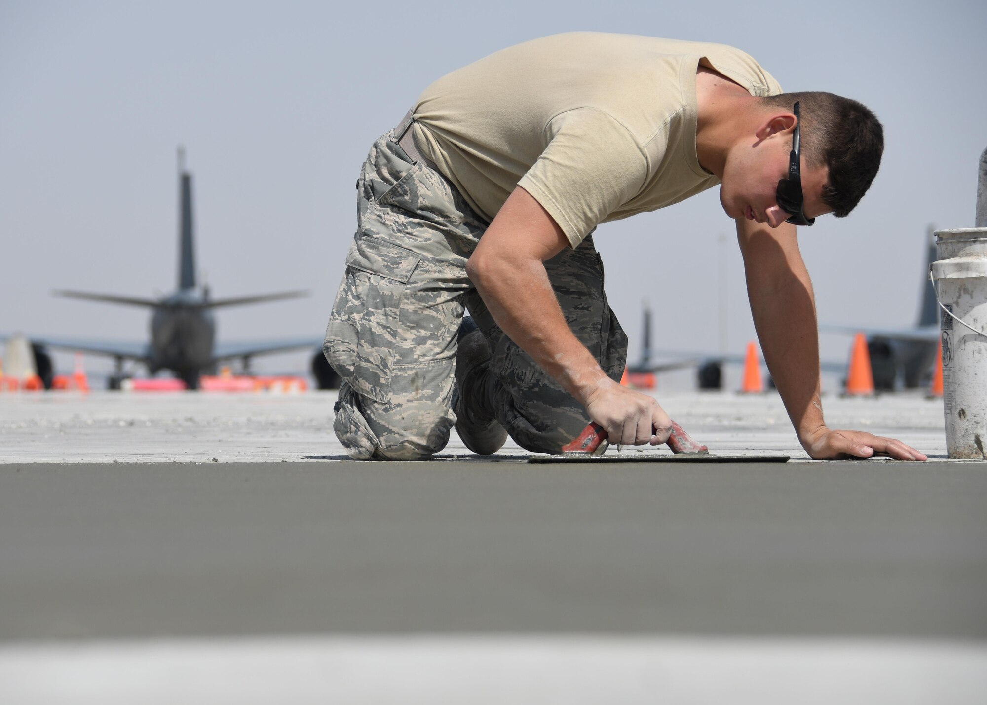 U.S. Air Force Airman 1st Class Jeremy Majors, a heavy equipment and constructions apprentice with the 379th Expeditionary Civil Engineer Squadron Pavements and Equipment Flight, “edges” fresh concrete at Al Udeid Air Base, Qatar, Feb. 21, 2017. Putting an edge in concrete helps direct where the concrete will crack to allow room for it to expand and contract with heat.(U.S. Air Force photo by Senior Airman Miles Wilson)