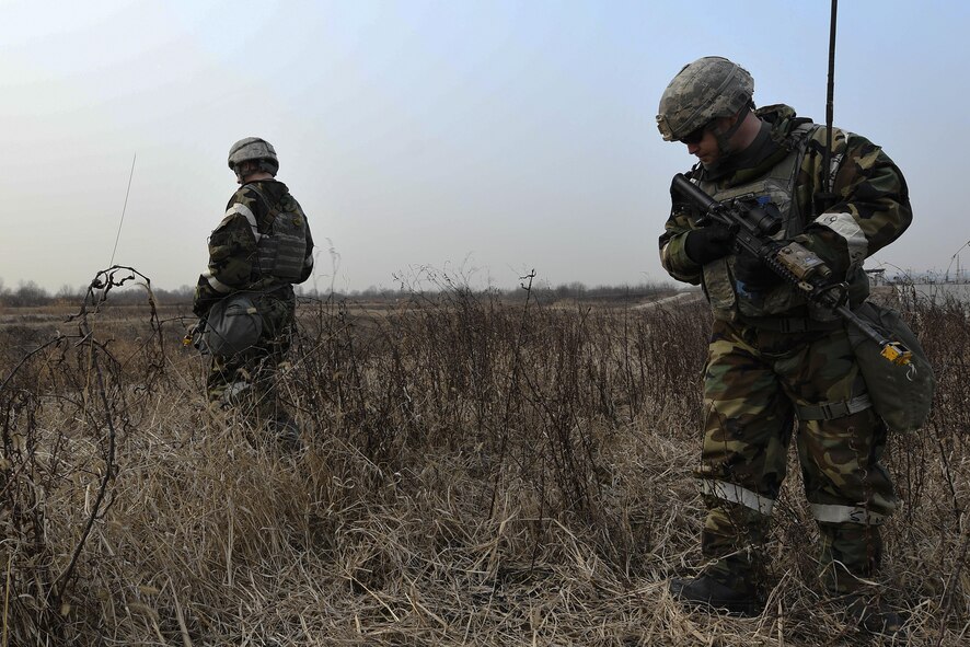 U. S. Air Force Staff Sgt. William Summerfield, 51st Security Forces Squadron base defense operations center controller, conduct an “outside the wire” perimeter check during Exercise Beverly Herd 17-1 at Osan Air Base, Republic of Korea, March 1, 2017. Defenders train and integrate with host nation counterparts to be ready to defend the base and its personnel at all times. (U.S. Air Force photo by Airman 1st Class Gwendalyn Smith)