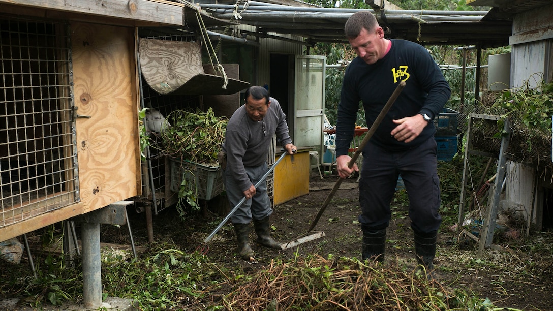 Gunnery Sgt. Todd Groves feeds one of the many pigs on Bokusei Kinjo’s farm, near Camp Hansen, Okinawa, Japan, Feb. 23, 2017. Groves, a maintenance chief with Small Craft Repair Platoon, Expeditionary Operations Training Group, III Marine Expeditionary Force, was a pig farmer in Fulton, Missouri, before joining the Marine Corps. Now, he has found a place in Okinawa he can call home. (U.S. Marine Corps photo by Lance Cpl. Bernadette Wildes)