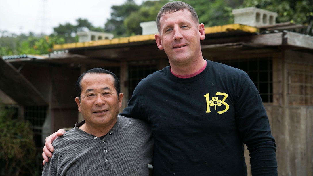 Gunnery Sgt. Todd Groves and Bokusei Kinjo at Kinjo’s farm, near Camp Hansen, Okinawa, Japan, Feb. 23, 2017. Groves is a maintenance chief with Small Craft Repair Platoon, Expeditionary Operations Training Group, III Marine Expeditionary Force, and Kinjo is a local Japanese farmer. Groves, from Fulton, Missouri, was a pig farmer growing up and has now found a place he can call home on Kinjo’s farm. He has helped to take care of the land and the animals on Kinjo’s farm for the last two years. (U.S. Marine Corps photo by Lance Cpl. Bernadette Wildes)