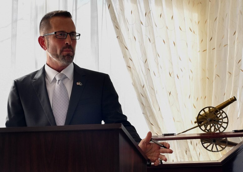 Clint Lock, U.S. Air Forces in Europe human resources specialist, speaks during a dual retirement ceremony on Ramstein Air Base, Germany, Feb. 24, 2017. John and Colynn Hamilton, USAFE management analyst and human resources specialist respectively, as well as husband and wife, retired after serving over 80 years combined as government employees. (U.S Air Force photo by Senior Airman Tryphena Mayhugh)