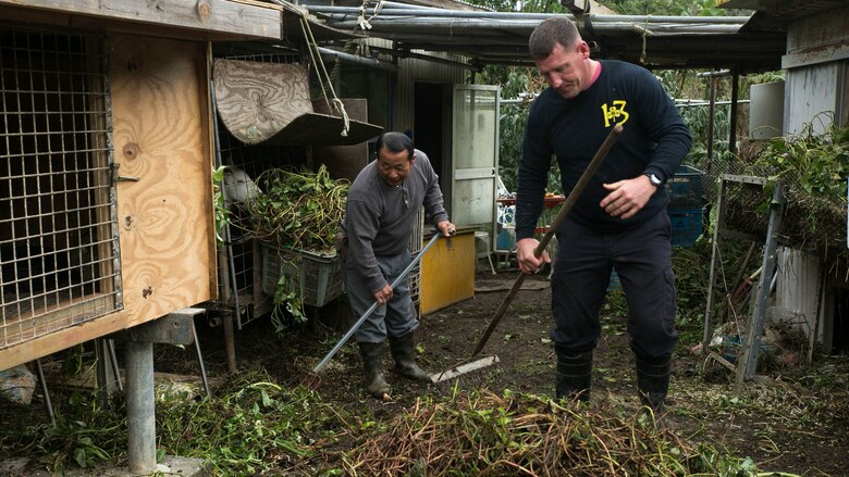 Gunnery Sgt. Todd Groves works alongside Bokusei Kinjo at Kinjo’s farm, near Camp Hansen, Okinawa, Japan, Feb. 23, 2017. Groves, a maintenance chief with Small Craft Repair Platoon, Expeditionary Operations Training Group, III Marine Expeditionary Force, was a pig farmer in Fulton, Missouri, before joining the Marine Corps. Now, he has found a place in Okinawa he can call home. (U.S. Marine Corps photo by Lance Cpl. Bernadette Wildes)