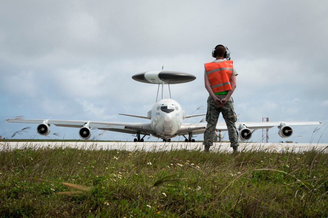 U.S. Air Force Senior Airman Austin Perry from the 962nd Aircraft Maintenance Unit prepares to marshal an E-3 Sentry from the 961st Airborne Air Control Squadron during annual exercise Cope North Feb. 23, 2017, at Andersen Air Force Base, Guam. The exercise provides opportunities for Airmen from different units and nations to train and work with each other’s airframes. The Sentry has rotating radar that has a range of more than 250 miles, providing early warning and detection for missions. (U.S. Air Force photo by Senior Airman John Linzmeier)