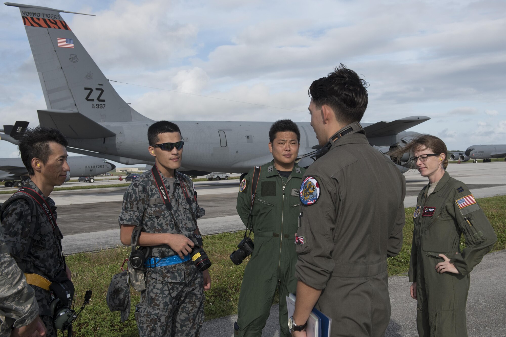 U.S. Air Force Airman 1st Class Luke Story, 909th Air Refueling Squadron boom operator, prepares to conduct aerial refueling while being observed by Japan Air Self-Defense Force 1st Lt. Yoshifumu Takase March 1, 2017, off the coast of Guam. The refueling was conducted for exercise Cope North, an annual gathering of Japanese, U.S. and Australian service members who train to increase combat readiness and interoperability. (U.S. Air Force photo by Senior Airman John Linzmeier)