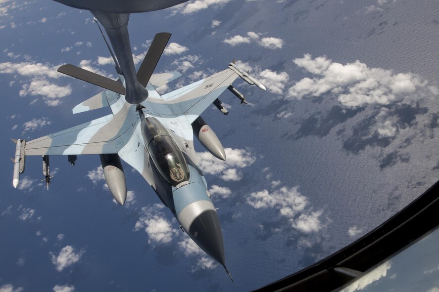 U.S. Air Force Airman 1st Class Luke Story, 909th Air Refueling Squadron boom operator, prepares to conduct aerial refueling while being observed by Japan Air Self-Defense Force 1st Lt. Yoshifumu Takase March 1, 2017, off the coast of Guam. The refueling was conducted for exercise Cope North, an annual gathering of Japanese, U.S. and Australian service members who train to increase combat readiness and interoperability. (U.S. Air Force photo by Senior Airman John Linzmeier)
