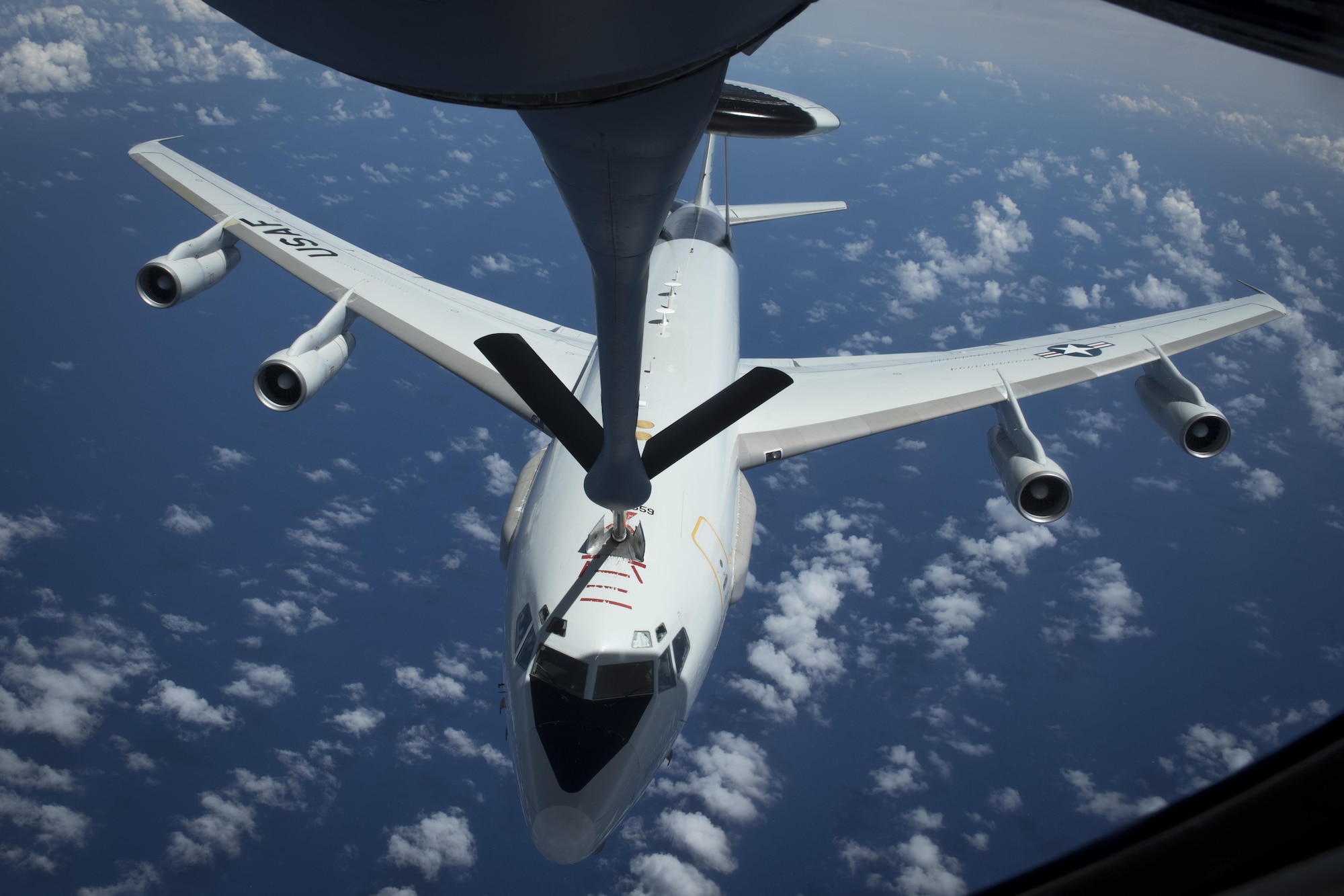 U.S. Air Force Airman 1st Class Luke Story, 909th Air Refueling Squadron boom operator, prepares to conduct aerial refueling while being observed by Japan Air Self-Defense Force 1st Lt. Yoshifumu Takase March 1, 2017, off the coast of Guam. The refueling was conducted for exercise Cope North, an annual gathering of Japanese, U.S. and Australian service members who train to increase combat readiness and interoperability. (U.S. Air Force photo by Senior Airman John Linzmeier)