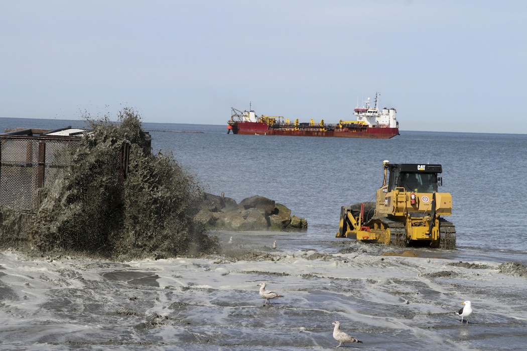 NORFOLK, Va. -- Norfolk District, U.S. Army Corps of Engineers’ contractors from Great Lakes Dredging and Dock Company pump sand dredged from the bottom of the Chesapeake Bay up to Norfolk, Virginia’s Ocean View Beach. The sand is part of a $34.5 million project to reduce storm damage risk to infrastructure along a 7.3 mile stretch of waterfront, which is susceptible to damage during costal storms. Once complete, the beach will be 60 feet wide and slope up to 5 feet above mean low water. (U.S. Army photo/Patrick Bloodgood)