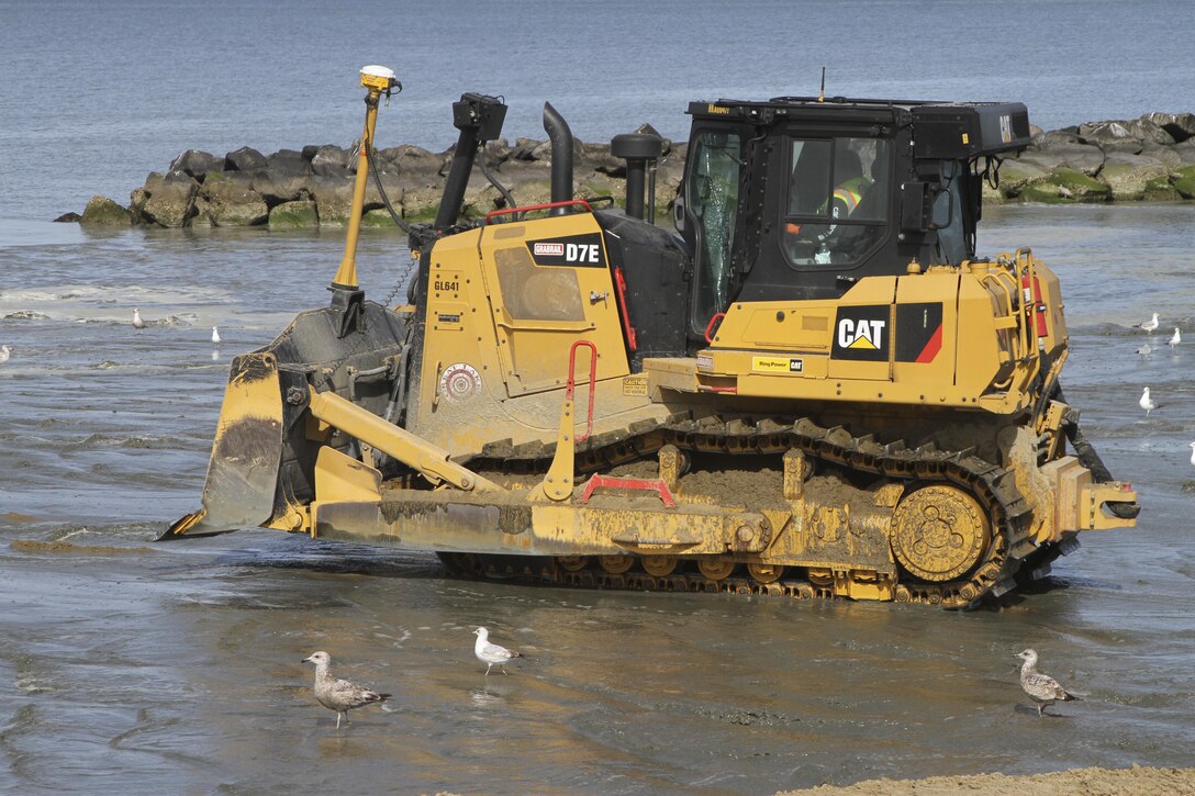 NORFOLK, Va. -- Norfolk District, U.S. Army Corps of Engineers’ contractors from Great Lakes Dredging and Dock Company use bulldozers to push sand dredged from the bottom of the Chesapeake Bay into place along Norfolk, Virginia’s Ocean View Beach. The sand is part of a $34.5 million project to reduce storm damage risk to infrastructure along a 7.3 mile stretch of waterfront, which is susceptible to damage during costal storms. Once complete, the beach will be 60 feet wide and slope up to 5 feet above mean low water. (U.S. Army photo/Patrick Bloodgood)