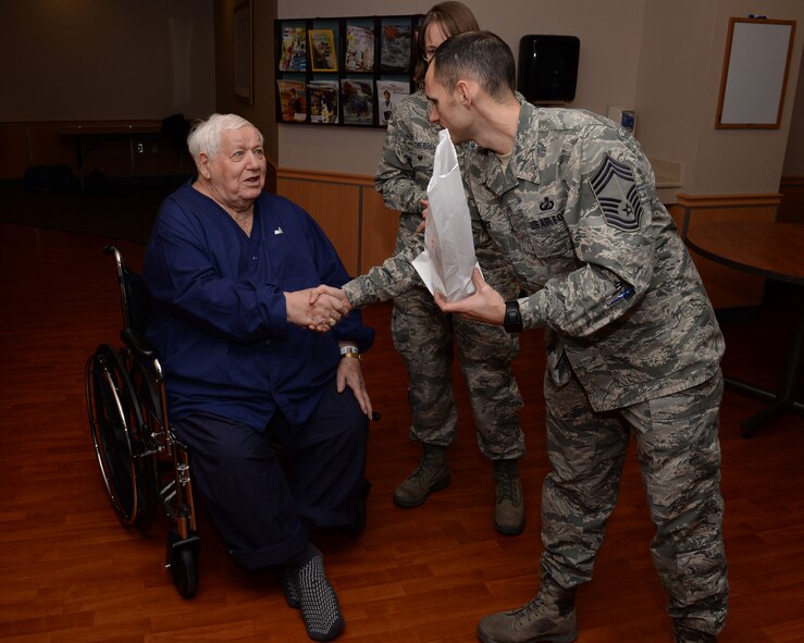 Chief Master Sgt. David Rice (right), 88th Comptroller Squadron manager, shakes hands with Wayne Weaver, Navy veteran and patient at the VA Medical Center, Feb. 14. Rice and Col. Elena Oberg, 88th Air Base Wing vice commander, gave Weaver a valentine’s gift bag during the VA’s Valentine’s for Veterans event as part as National Salute to Veterans week. (U.S. Air Force photo/Michelle Gigante)