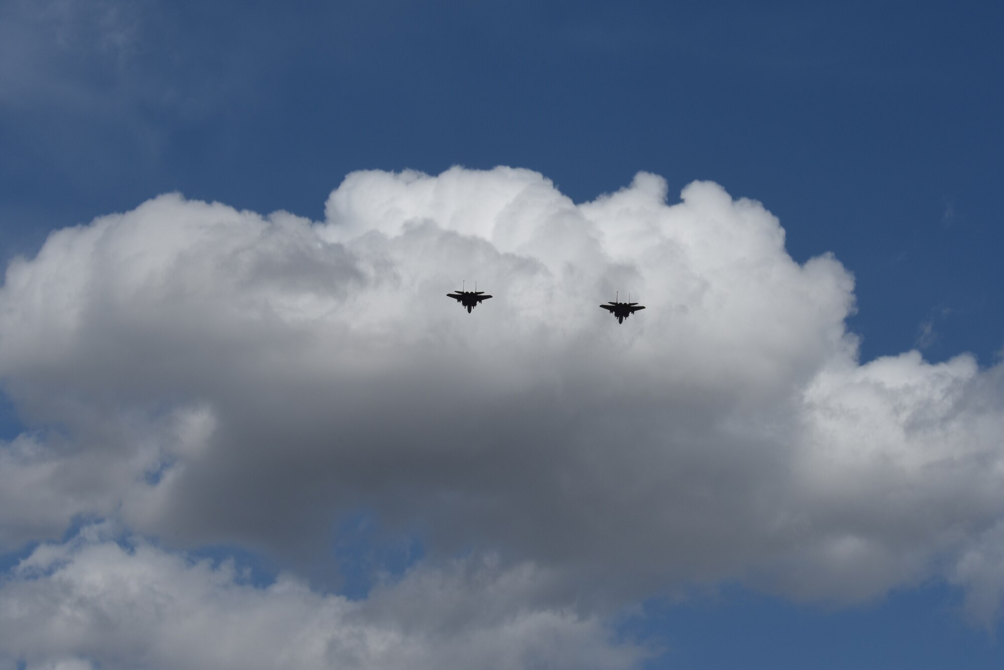 Two F-15E Strike Eagles perform a fly over during a Freedom Classic baseball series game, Feb. 25, 2017, at Grainger Stadium in Kinston, North Carolina. During the game, there was a patriotic ceremony honoring men and women who have served or are currently serving in the military.  (U.S. Air Force photo by Airman Miranda A. Loera)