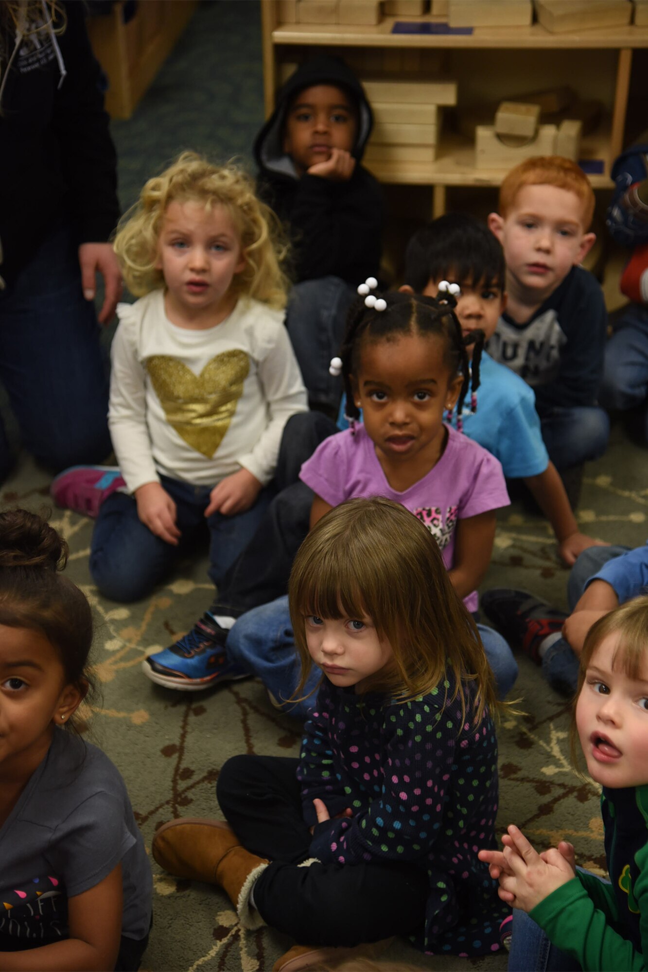 PETERSON AIR FORCE BASE, Colo. – Children listen to the reading of a youth’s financial savings book in the Child Development Center at the Peterson Air Force Base, Colo.,  Feb. 27, 2017. Military Saves Week teaches children of service members how to start saving money  (U.S. Air Force photo by Robb Lingley) 