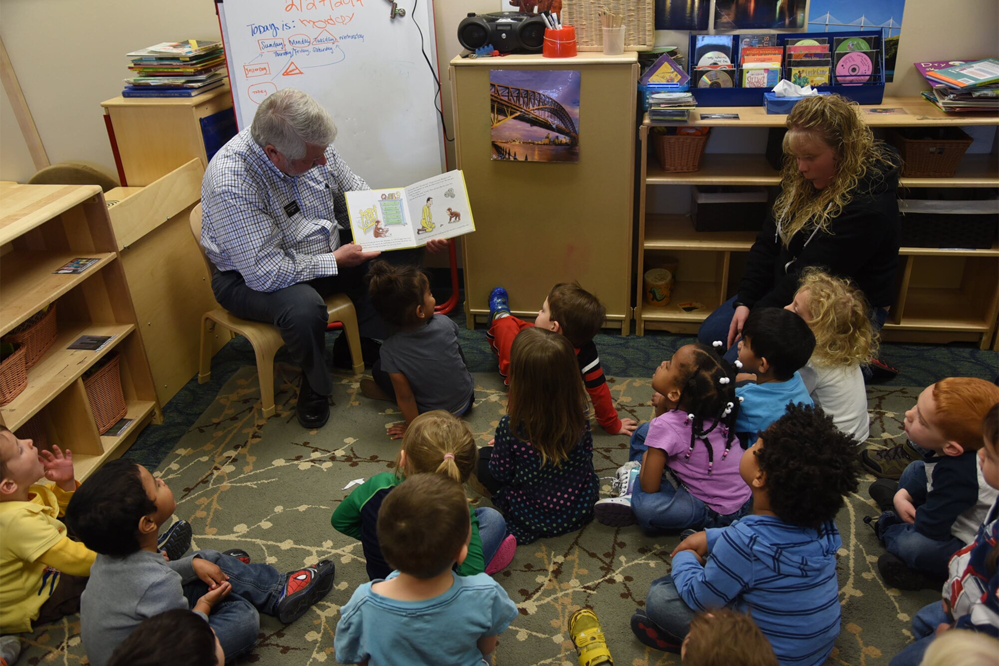 PETERSON AIR FORCE BASE, Colo. – Jim Girlando, Office of the Secretary of Defense personal financial councilman, reads a children’s financial savings book to children in the Child Development Center, at Peterson Air Force Base, Colo. Feb. 27, 2017.  Military Saves Week assists service members and their families to save money for their future. (U.S. Air Force photo by Robb Lingley)  