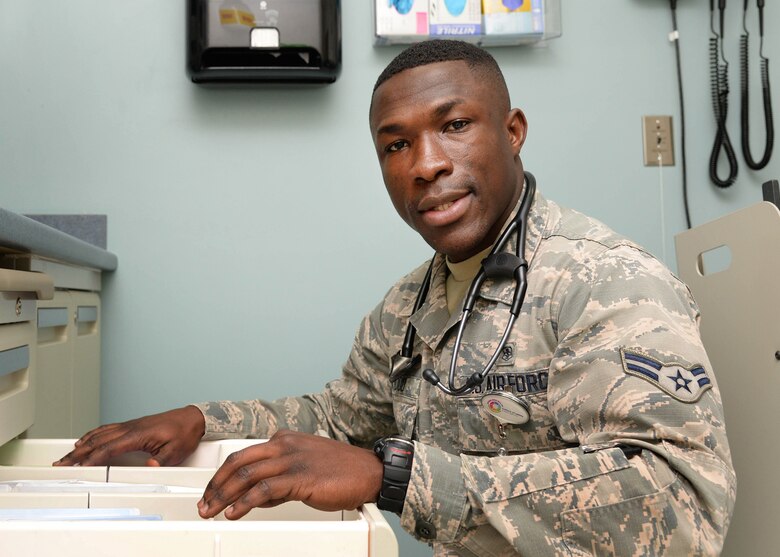 Airman 1st Class Jude Baidoo, a medical technician at the 66th Medical Squadron, searches through files in the Family Health Clinic in Building 1900 in January. Baidoo, who grew up in Ghana, Africa, immigrated to the Air Force in 2013 and enlisted in the Air Force in 2014. (U.S. Air Force photo by Linda LaBonte Britt)