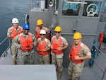 Chief Warrant Officer 2 Larry Lyons (blue helmet) serves at DLA Energy Pacific at Okinawa, Japan, as an operations and plans officer for bulk fuel receipt, storage, and inventory management and distribution. Part of his responsibilities are to help administer a six-month augmentee program where DLA Energy Pacific at Okinawa gives fuel Marines a chance to learn pipeline, lab, tanks, bunkering and tank gauging operations.