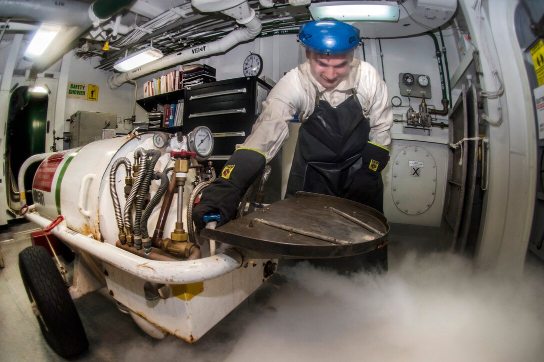 Navy Petty Officer 1st Class Caesare Reyes checks the pressure of a liquid oxygen cart aboard the aircraft carrier USS Carl Vinson in the South China Sea, Feb. 21, 2017. Reyes is a machinist’s mate. Navy photo by Petty Officer 2nd Class Sean M. Castellano